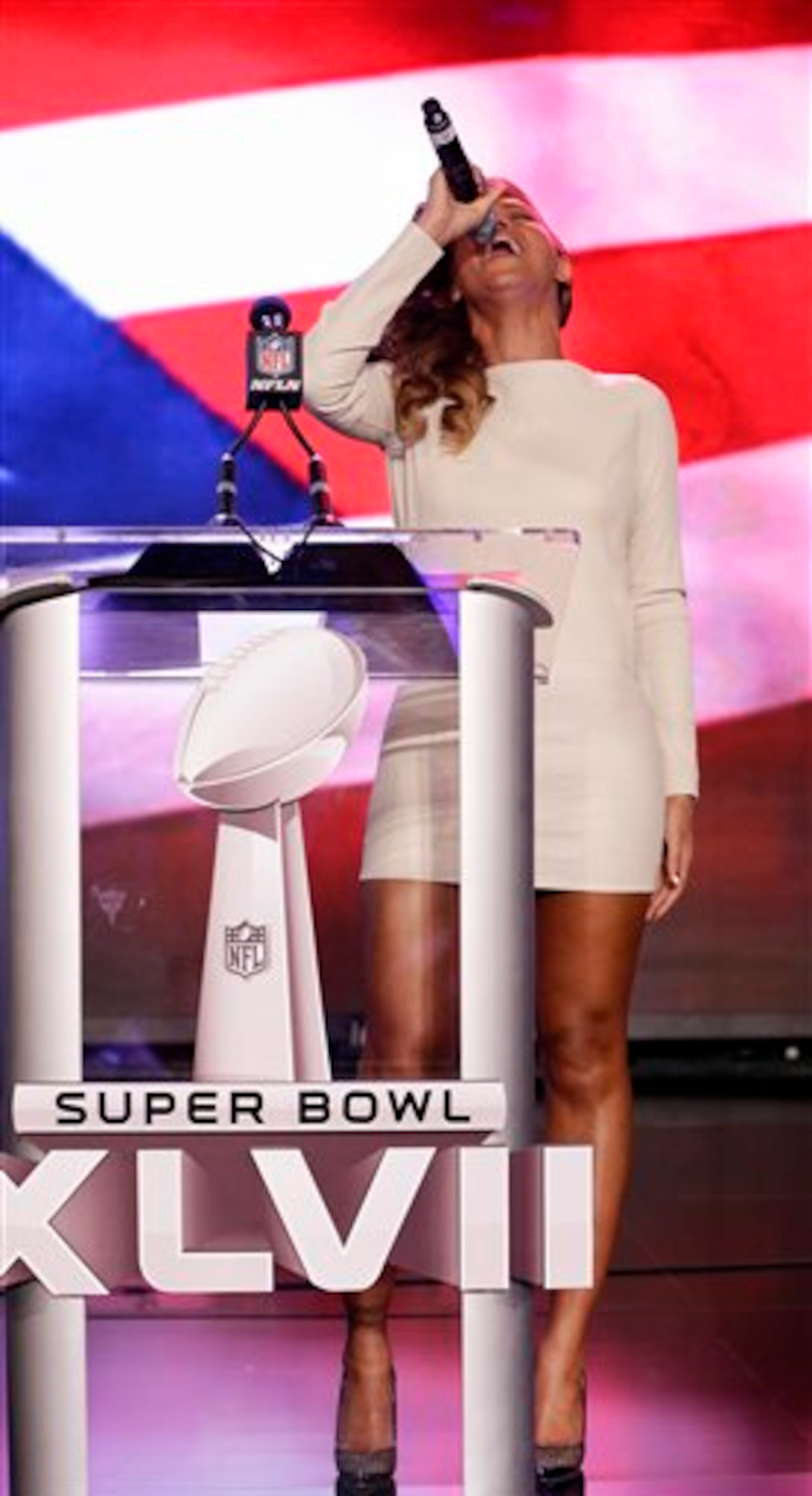 Beyonce sings the national anthem during a news conference Thursday, Jan. 31, 2013, in New Orleans. Beyonce's scheduled to perform during halftime of the NFL Super Bowl XLVII football game on Sunday, Feb. 3, 2013. (AP Photo/Matt Slocum)