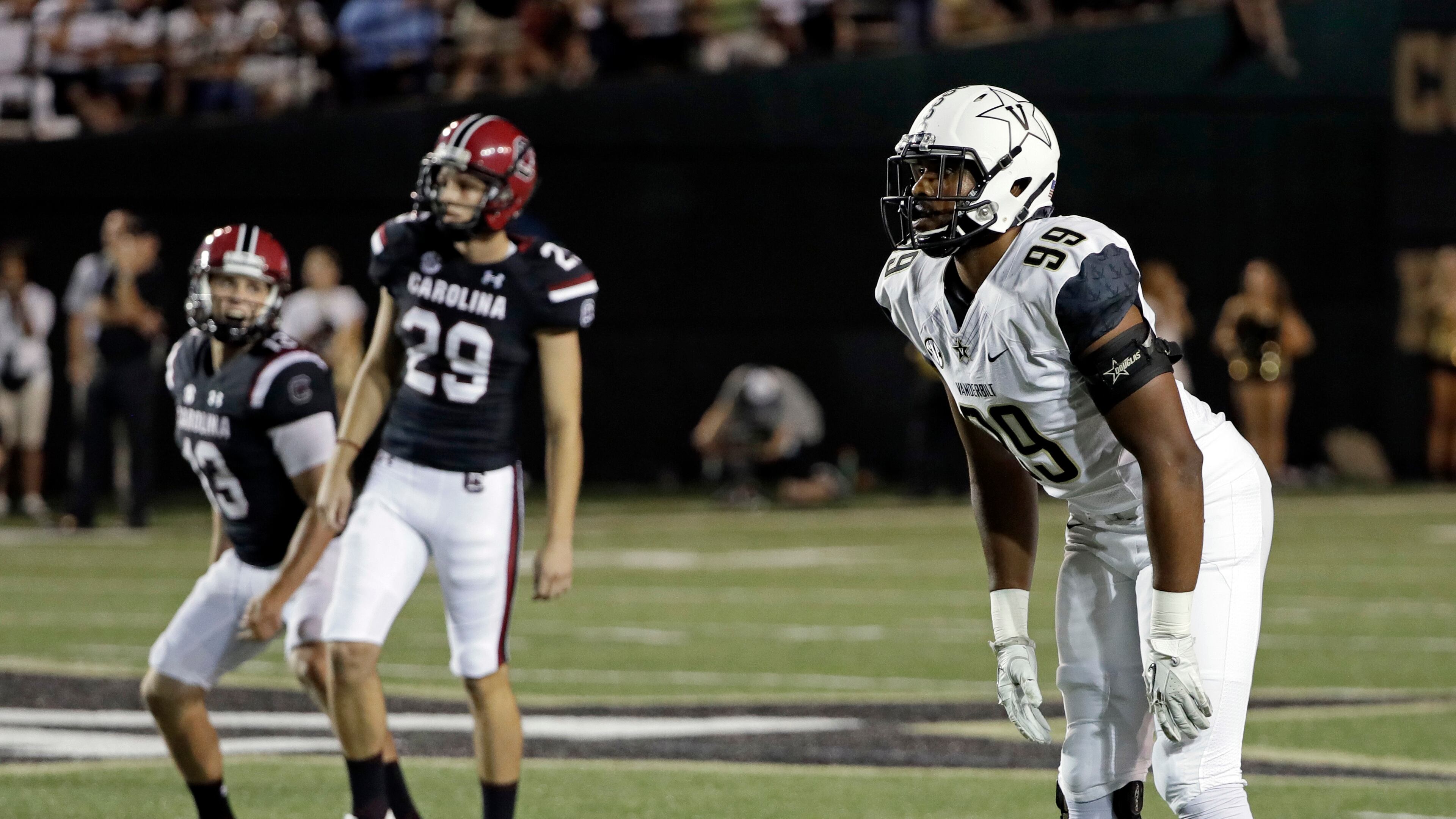 Vanderbilt'sLandon Stokes (99) watches a 55-yard field goal attempt along with South Carolina kicker Elliott Fry (29) and holder Sean Kelly (13) as Fry's kick with 35 seconds left in the fourth quarter beat Vanderbilt 13-10 in an NCAA college football game Thursday, Sept. 1, 2016, in Nashville, Tenn. (AP Photo/Mark Humphrey)