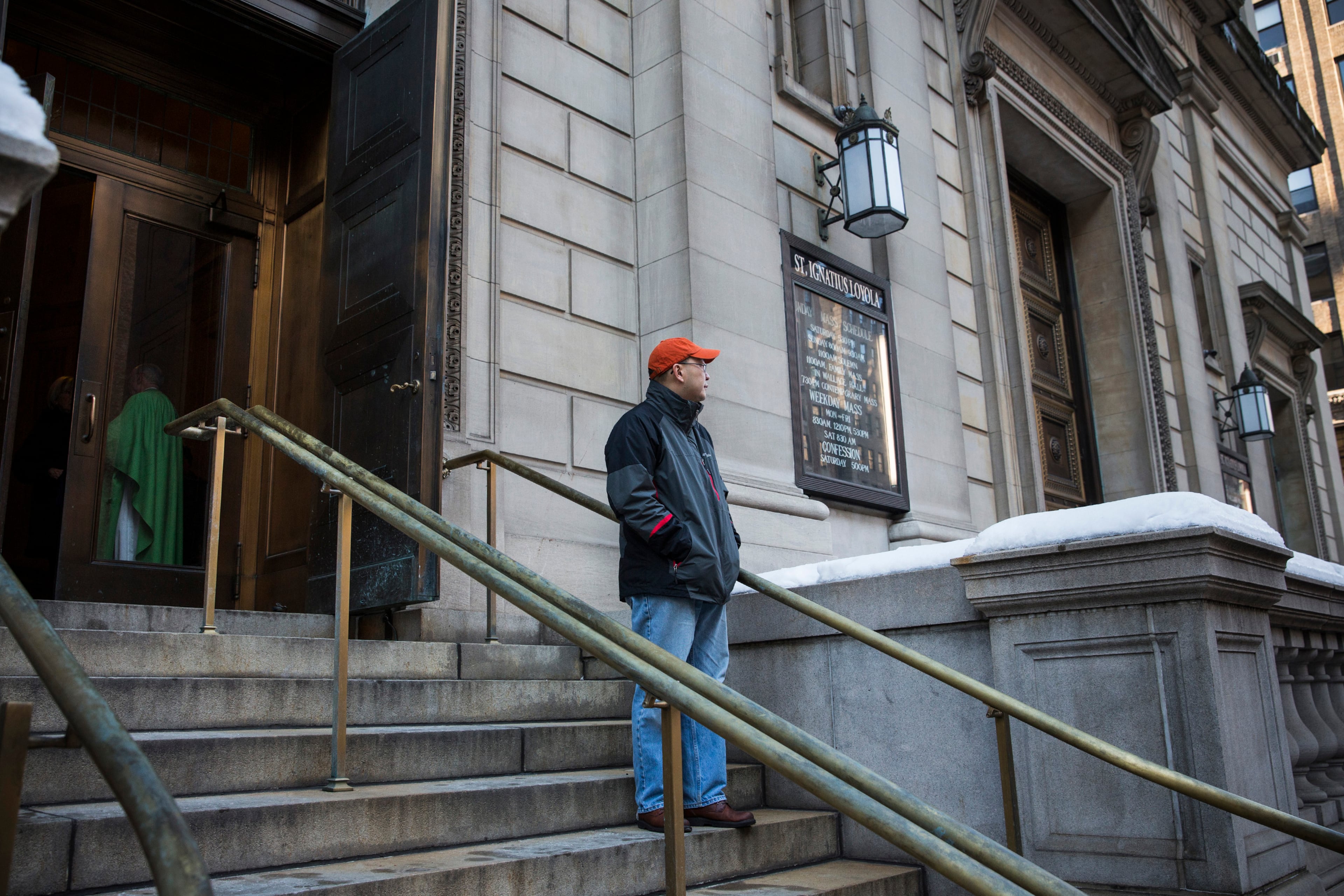 A man stands on the steps of St. Ignatius of Loyola Catholic Church, site of the funeral service for actor Philip Seymour Hoffman, who died of an alleged drug overdose on February 1, 2014, before the funeral service on February 7, 2014 in New York City. Hoffman was allegedly found dead in his bathroom with a needle in his arm.