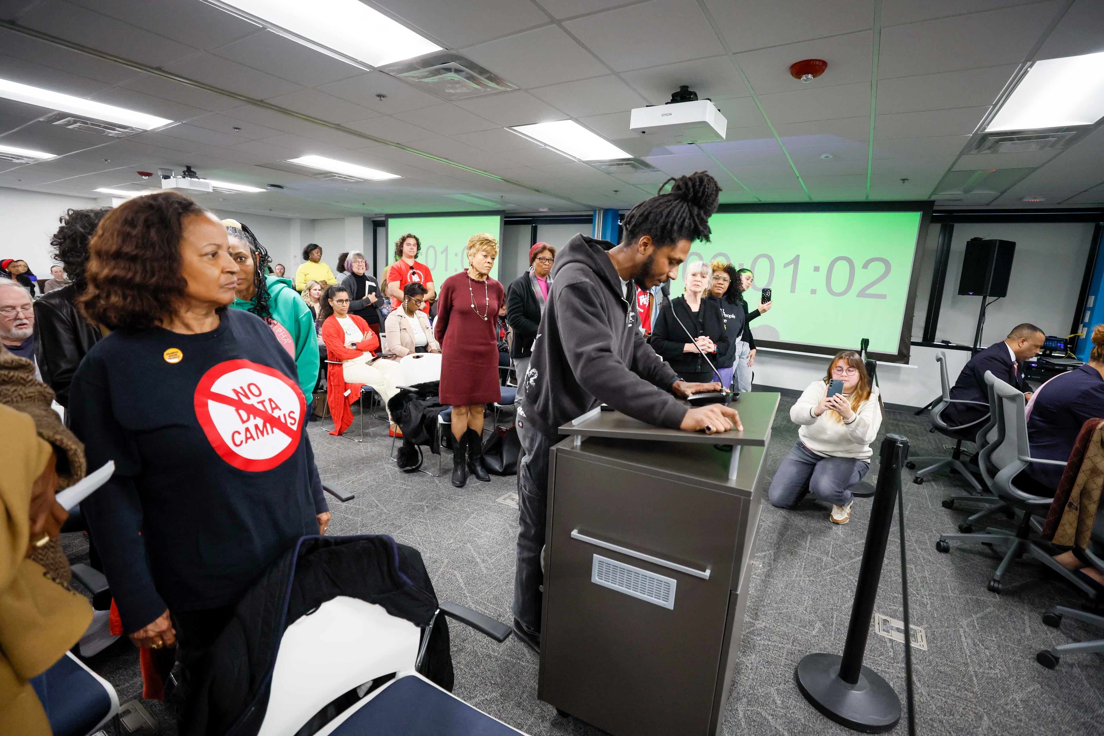 Rafi Powell is shown during public comments at the DeKalb Board of Commissioners meeting in Decatur on Tuesday, Dec. 16, 2025, opposing the construction of data centers. (Miguel Martinez/AJC)