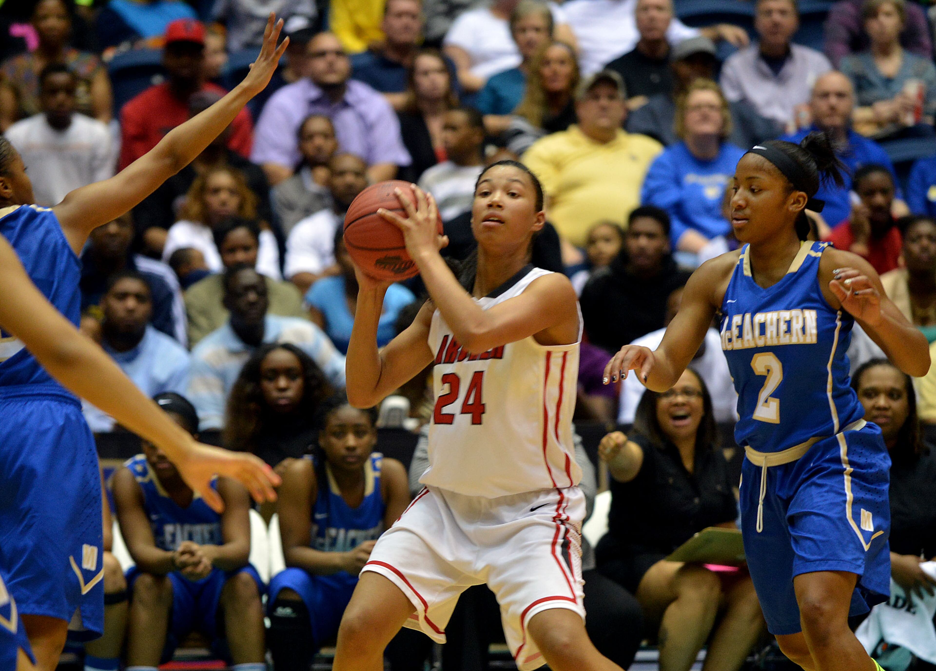 Archer Tigers Autumn Newby #24 looks to pass as McEachern Indians Te'a Cooper #2 works on defense during action in the first half. Coverage of the Class AAAAAA girls basketball championship between the McEachern Indians and Archer Tigers at the Macon Coliseum Saturday, March 8, 2014. McEachearn led 39-35 at the half.