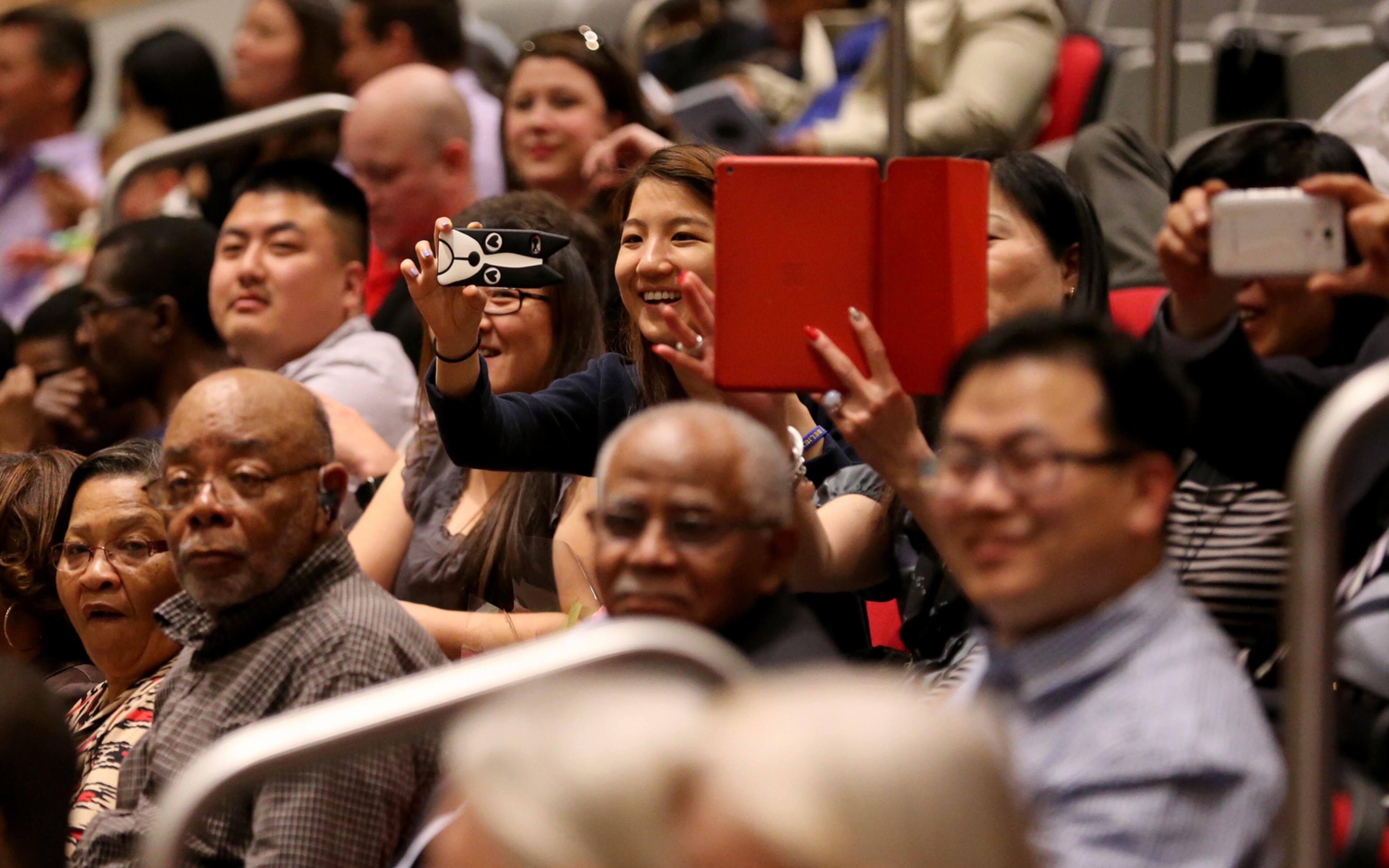POLICE GRADUATION--March 18, 2015 Atlanta: Family members shoot photos as new Atlanta Police officers graduate Wednesday evening March 18, 2015 at North Atlanta High School. Ben Gray / bgray@ajc.com