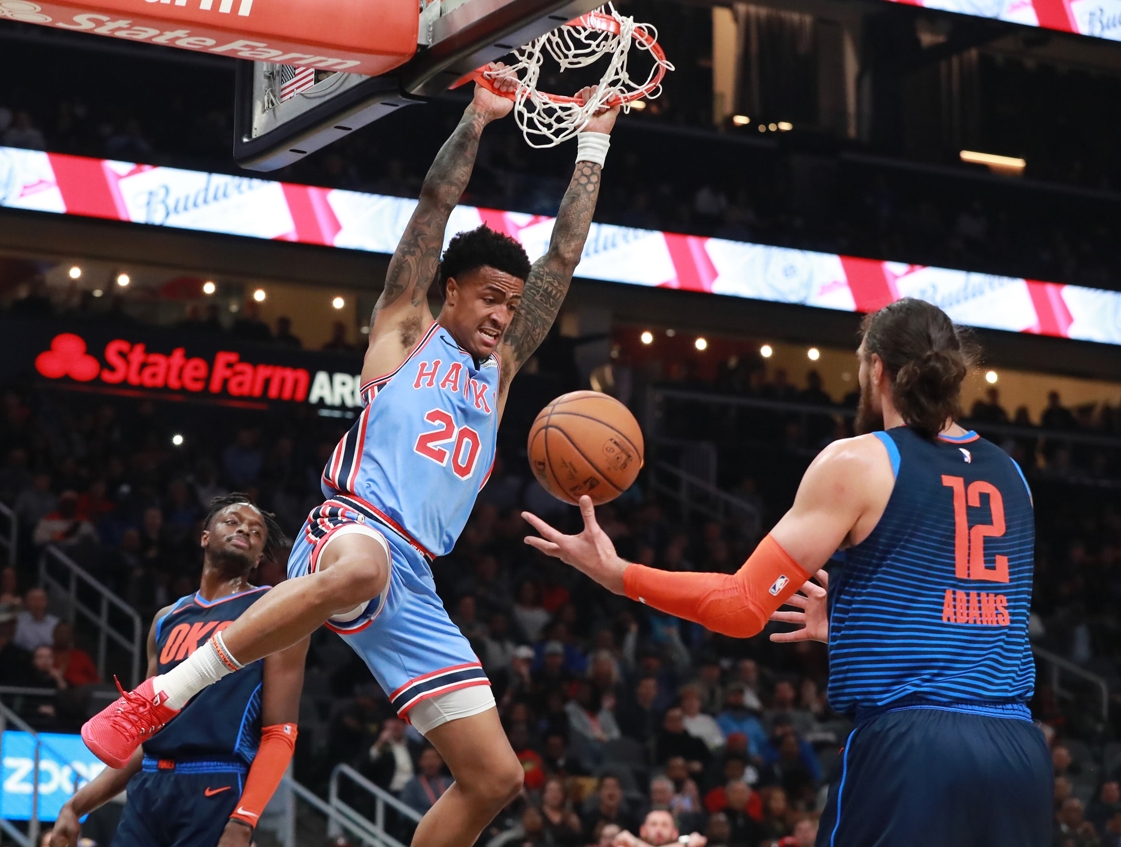 Jan. 15, 2019 Atlanta: Atlanta Hawks forward John Collins slams for two with Oklahoma City Thunder center Steven Adams looking on during the first half in a NBA basketball game on Tuesday, Jan. 15, 2019, at State Farm Arena in Atlanta. Curtis Compton/ccompton@ajc.com