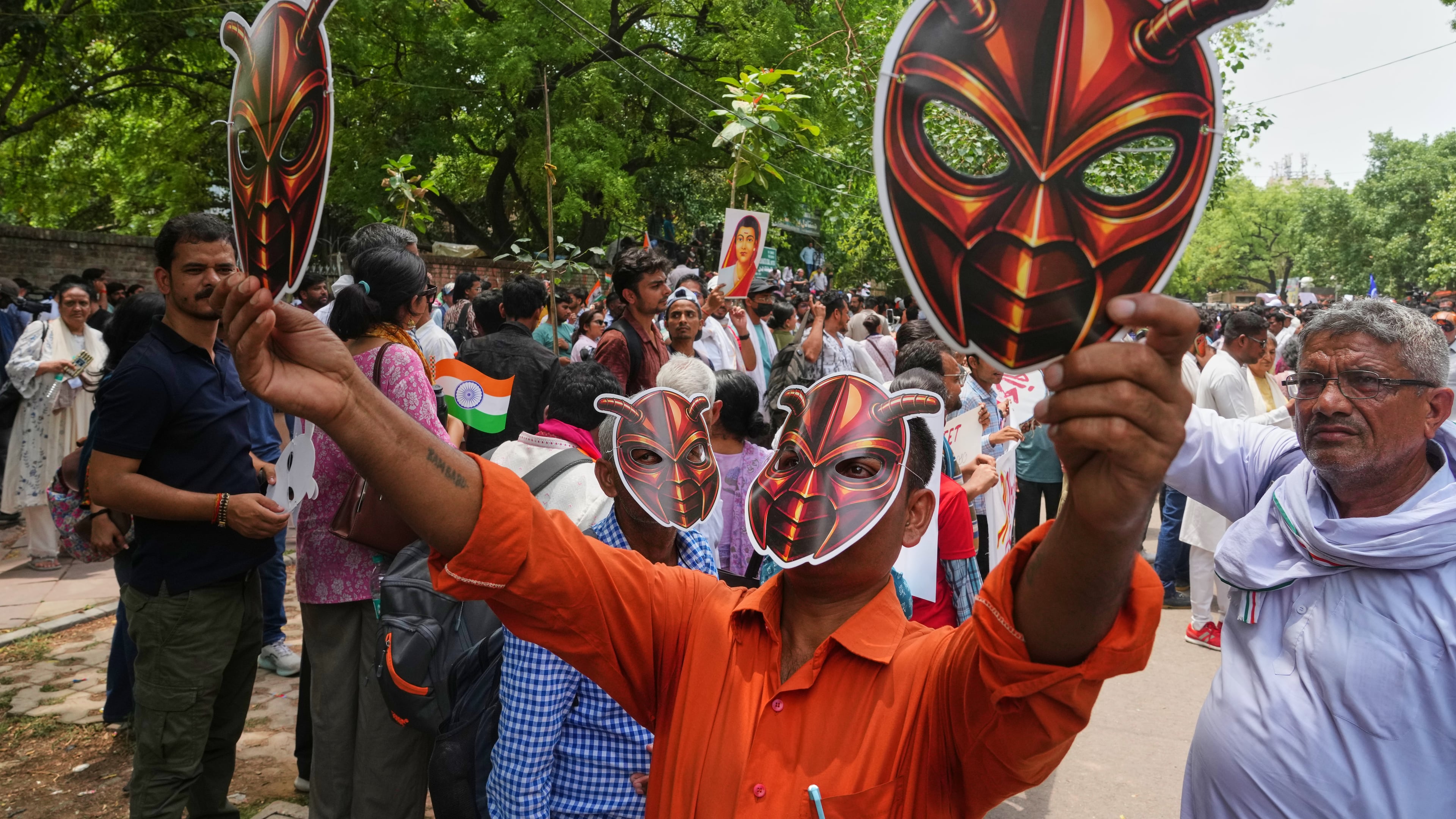 Supporters of the Cockroach Janta Party wear and display masks during a protest demonstration in New Delhi, India, Saturday, June 6, 2026. (AP Photo/Manish Swarup)