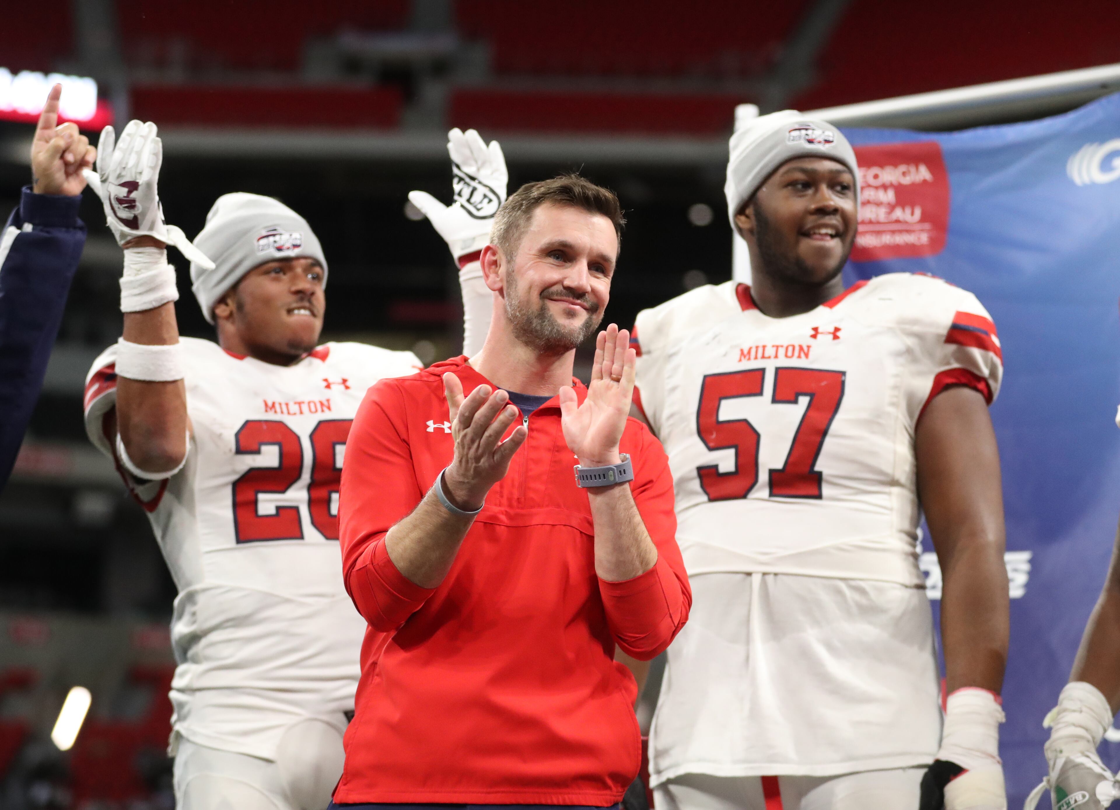 December 12, 2018 - Atlanta, Ga: Milton coach Adam Clack, center, celebrates with players Joseph Charleston, left, and Paul Tchio after their 14-13 win against Colquitt County in the Class AAAAAAA State Championship at Mercedes-Benz Stadium Wednesday, December 12, 2018, in Atlanta. Milton won 14-13. (JASON GETZ/SPECIAL TO THE AJC)