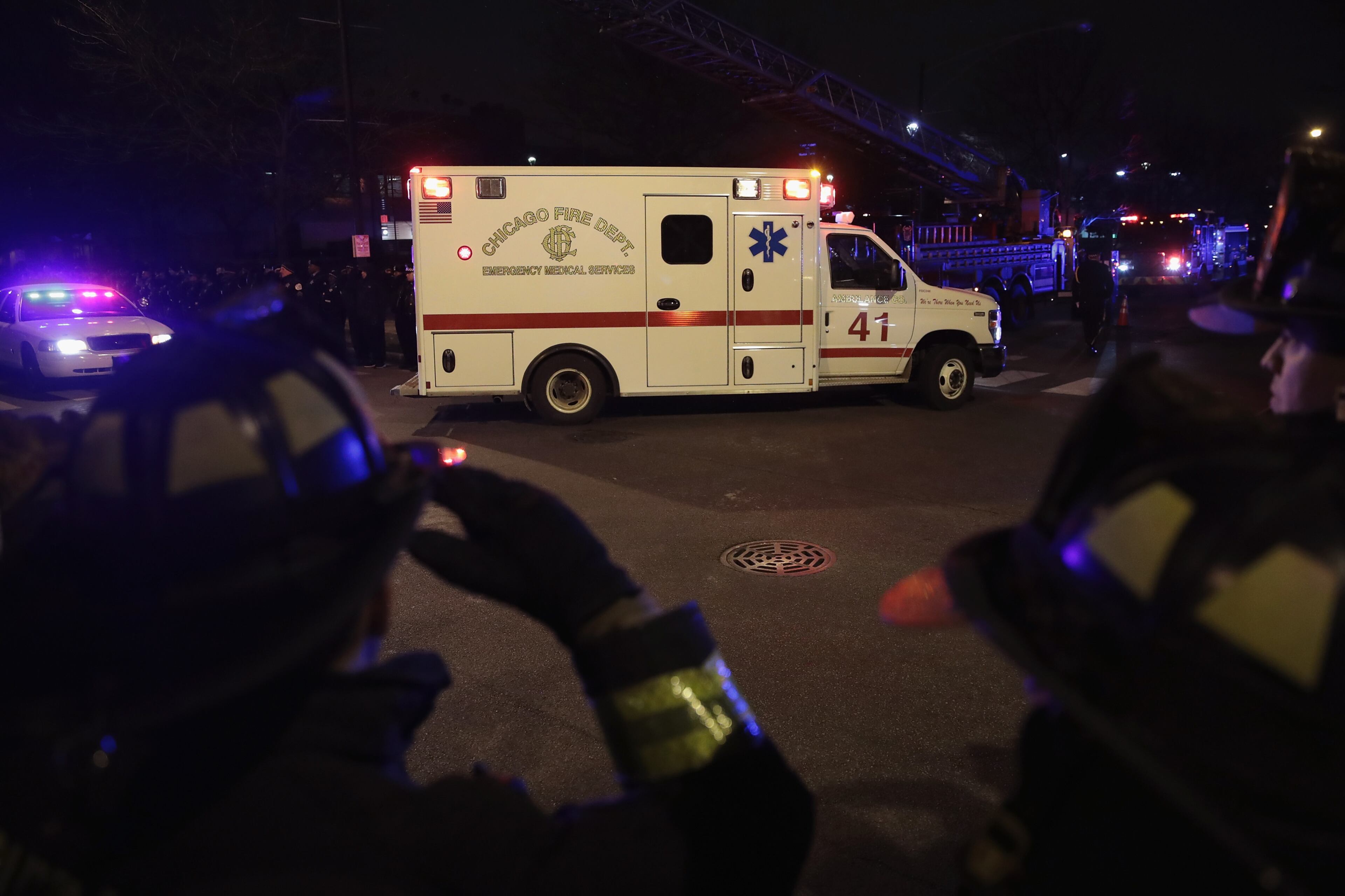 CHICAGO, IL - NOVEMBER 19: Firefighters and police officers salute as the ambulance carrying the remains of Chicago Police officer Samuel Jimenez arrive at the Cook County Medical Examiner's office on November 19, 2018 in Chicago, Illinois. Jimenez was killed today responding to a shooting at Mercy Hospital which also claimed the lives two hospital workers and the gunman. (Photo by Scott Olson/Getty Images)
