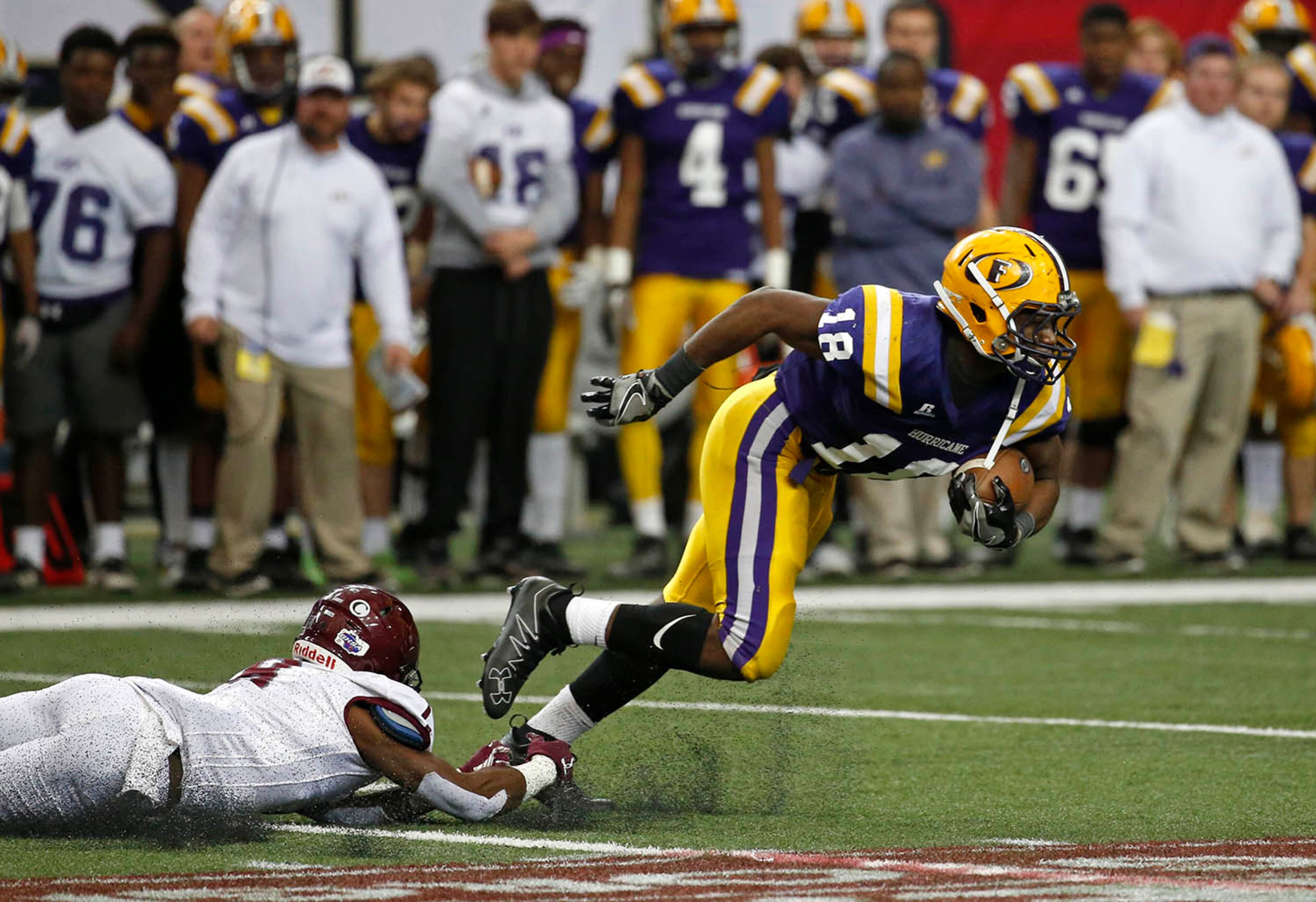 Fitzgerald running back JD King (18) gets past the tackle attempt by Benedictine defensive back Bobby Baker (8). (Jason Getz for the AJC)