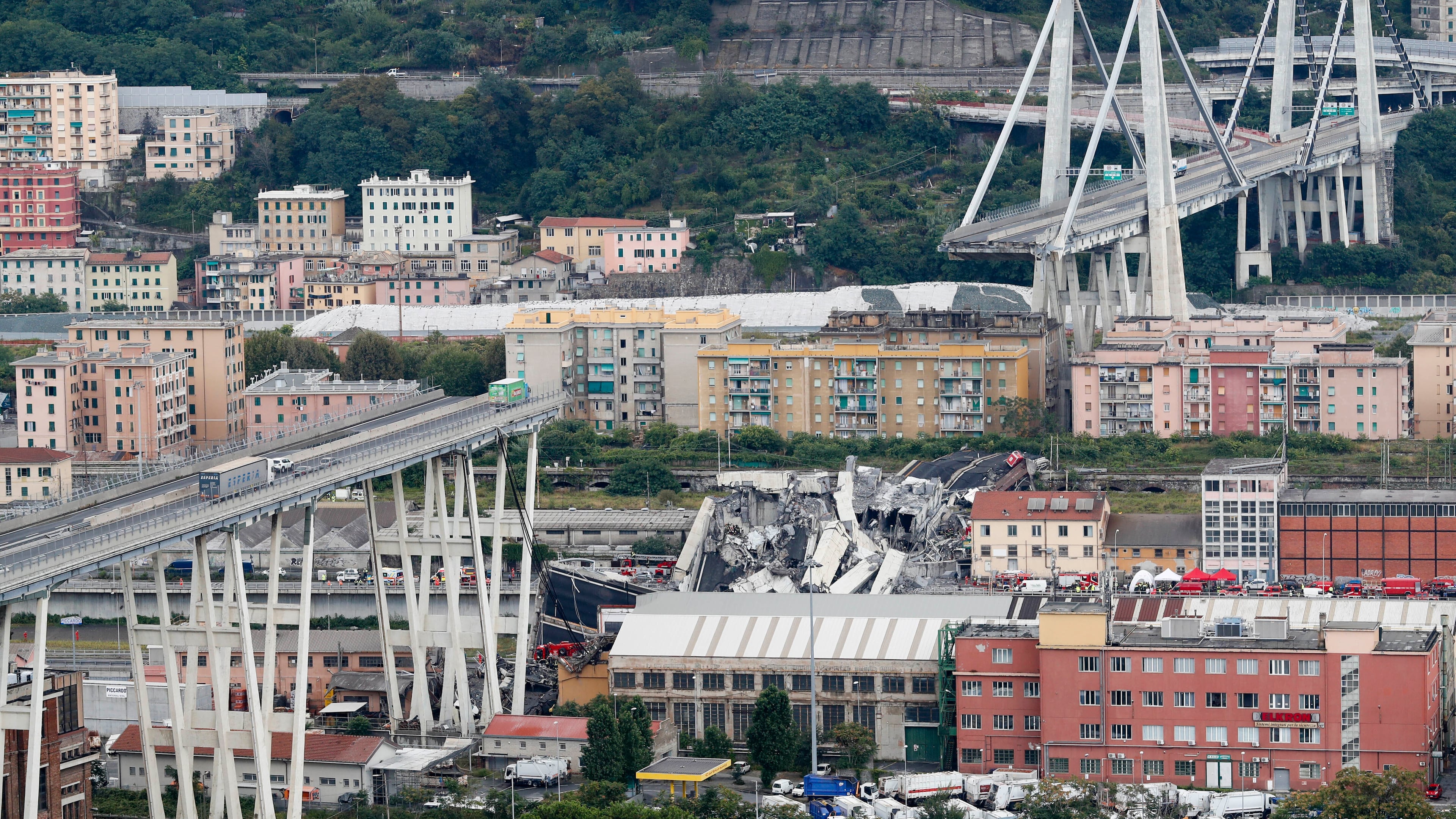 FILE - Cars are blocked on the Morandi highway bridge after a section of it collapsed, Aug. 14, 2018, in Genoa, northern Italy. (AP Photo/Antonio Calanni, File)