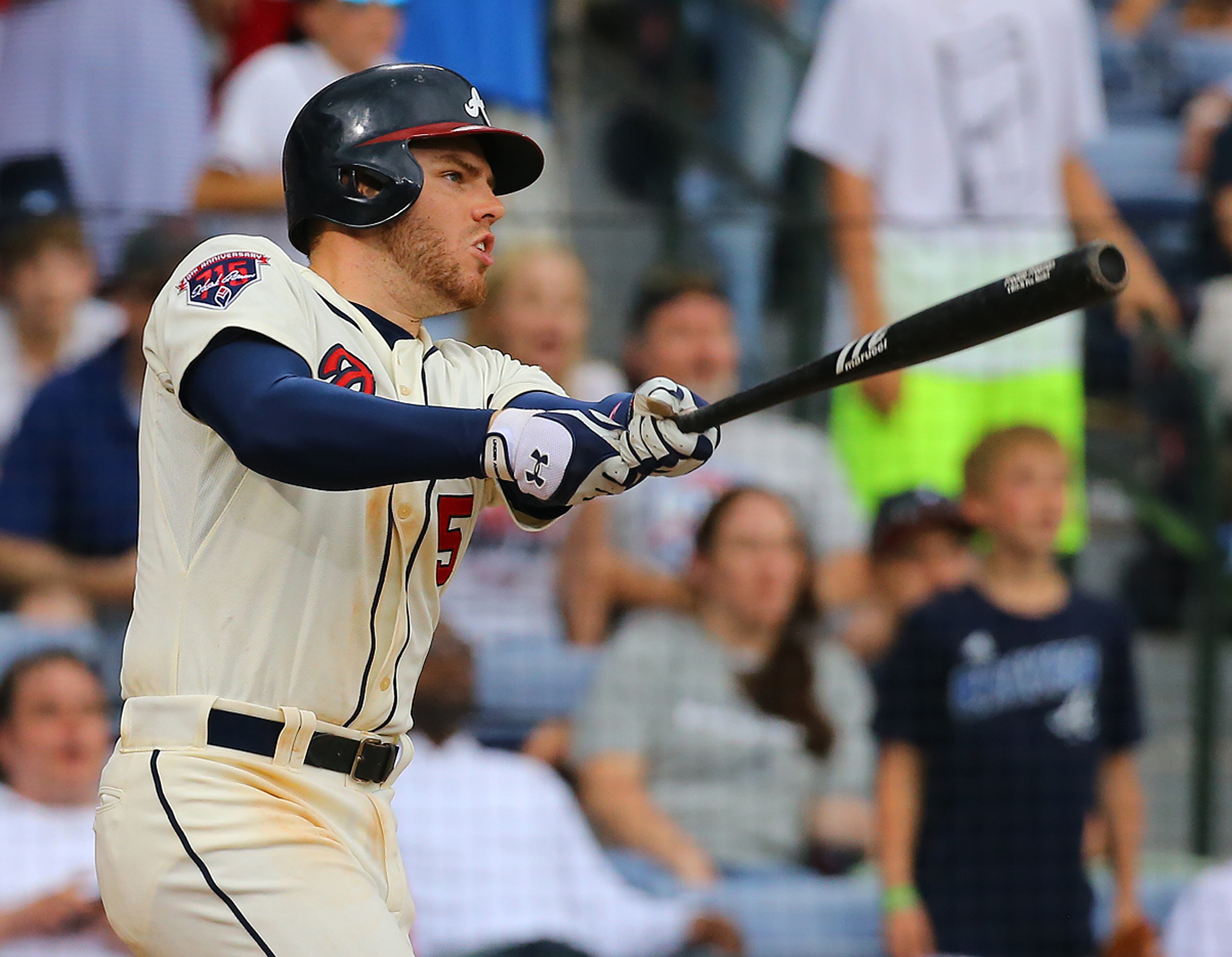 Freddie Freeman hits a game winning RBI single to beat the Reds 1-0 in the 10th inning of their MLB baseball game on Sunday, April 27, 2014, in Atlanta. CURTIS COMPTON / CCOMPTON@AJC.COM