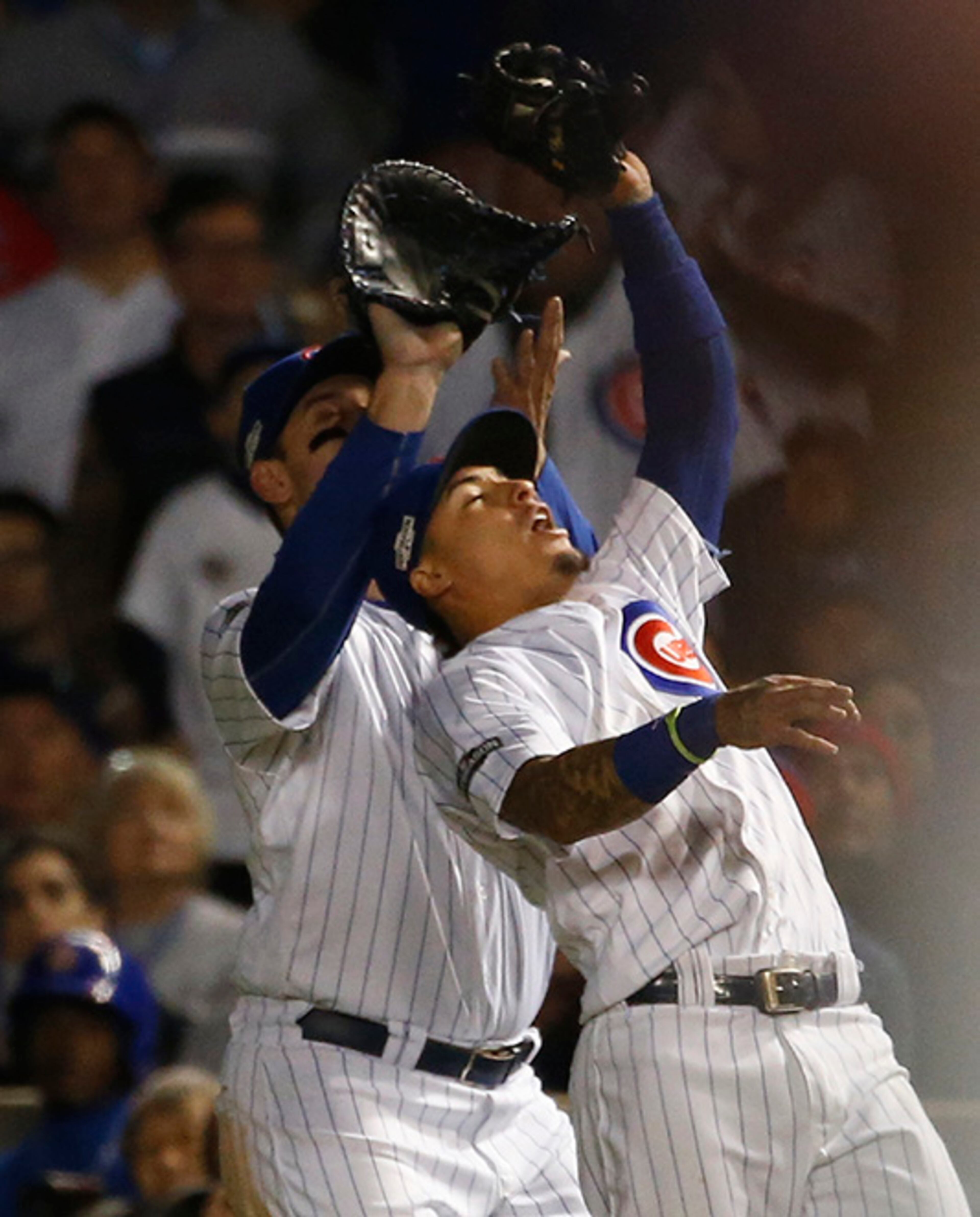 Chicago Cubs second baseman Javier Baez (9) catches a fly ball in front of first baseman Anthony Rizzo by Los Angeles Dodgers' Josh Reddick during the fifth inning of Game 6 of the National League baseball championship series Saturday, Oct. 22, 2016, in Chicago. (AP Photo/Nam Y. Huh)