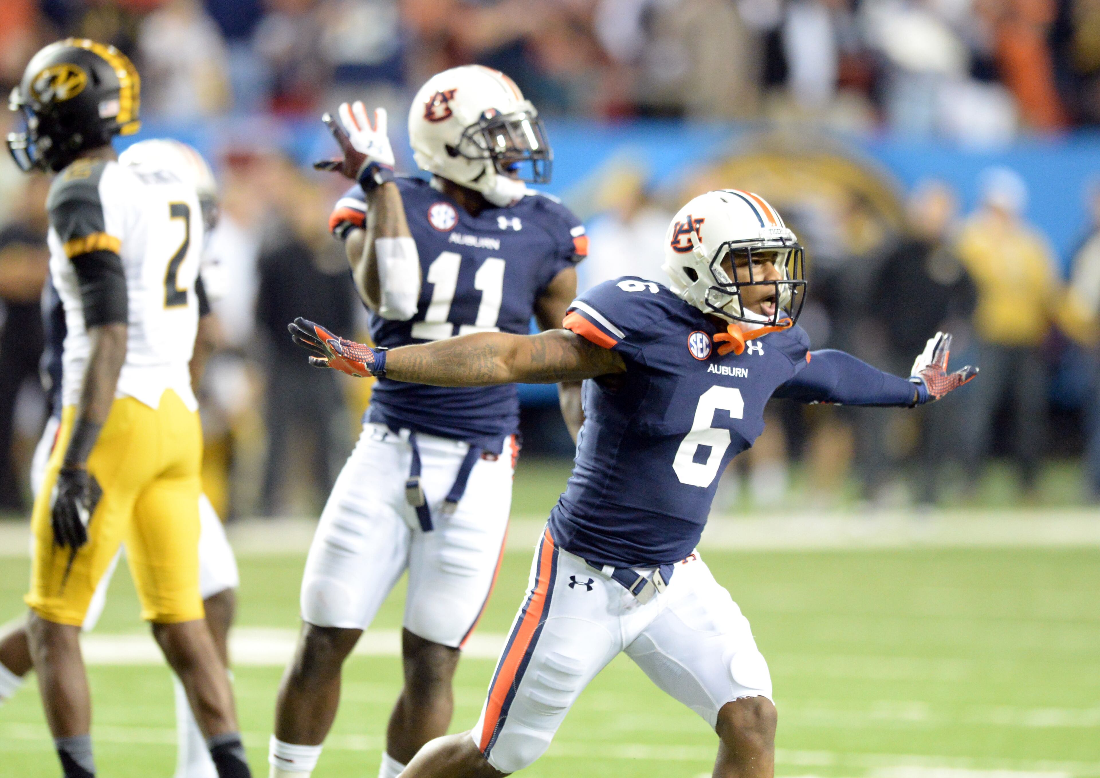 Auburn Tigers defensive back Jonathon Mincy (6) and Auburn Tigers cornerback Chris Davis (11) celebrate during the second half of the SEC Championship game at Georgia Dome on Saturday, December 7, 2013. Auburn Tigers won 59-42. HYOSUB SHIN / HSHIN@AJC.COM