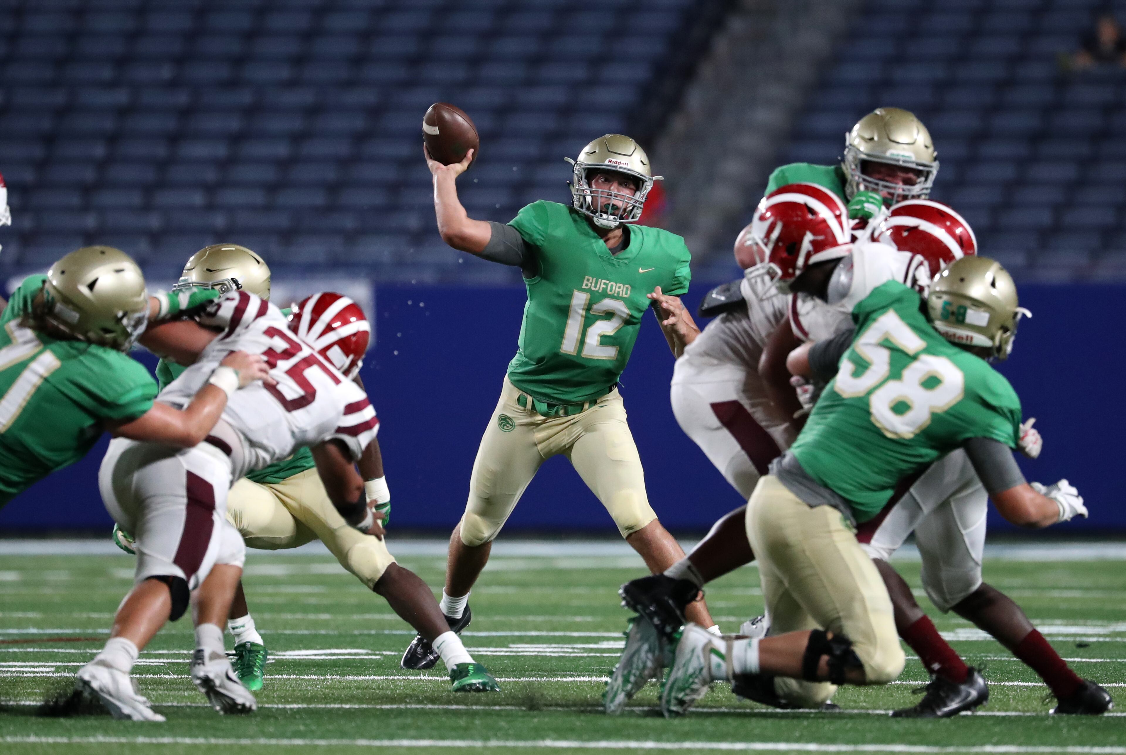 Buford quarterback Aaron McLaughlin (12) attempts a pass in the first half of their game against Hillgrove during the Corky Kell Classic at Georgia State Stadium Friday, August 18, 2017, in Atlanta.