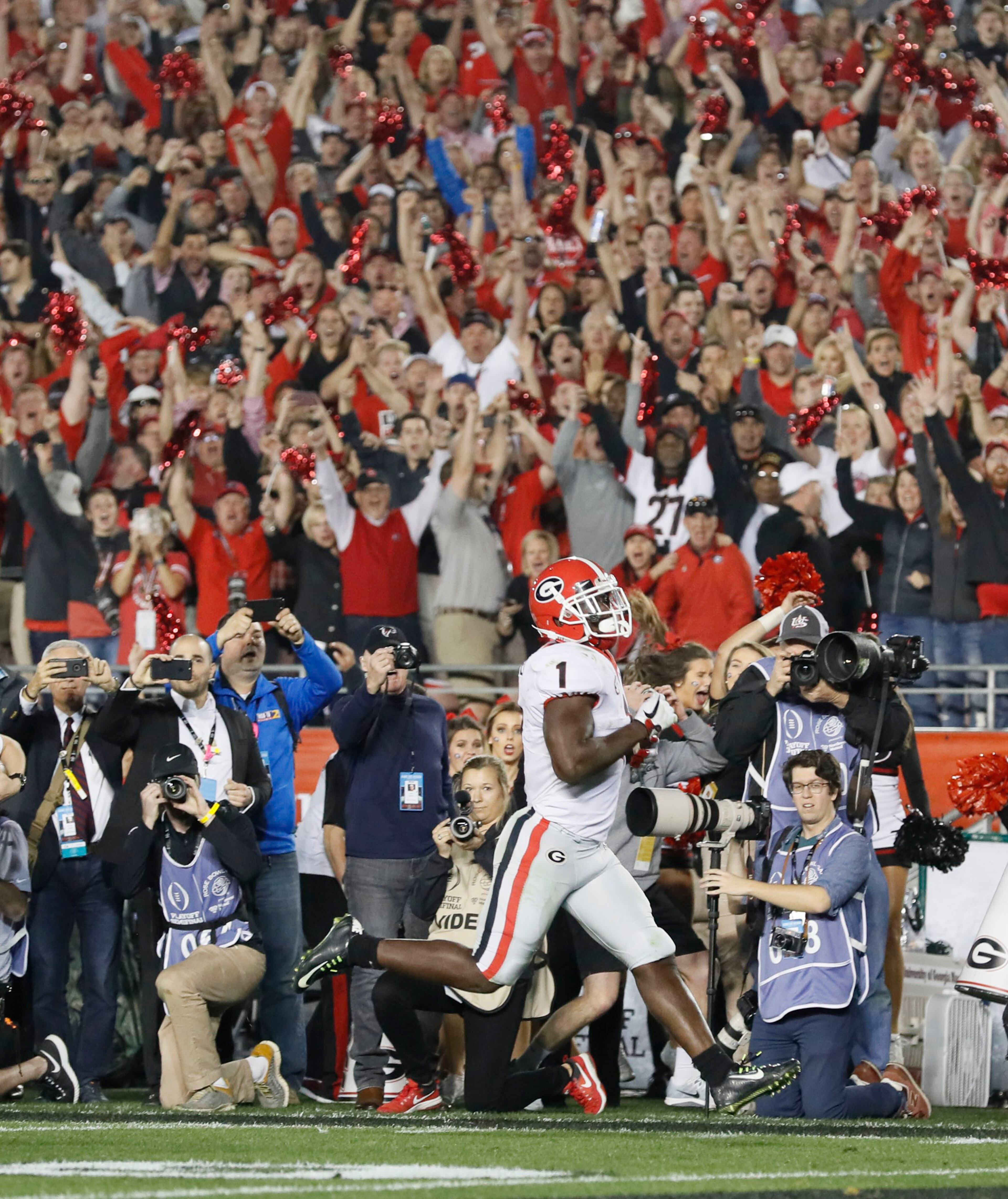 Georgia running back Sony Michel scores the winning touchdown in overtime at the college football playoff Semifinal at the Rose Bowl Monday .