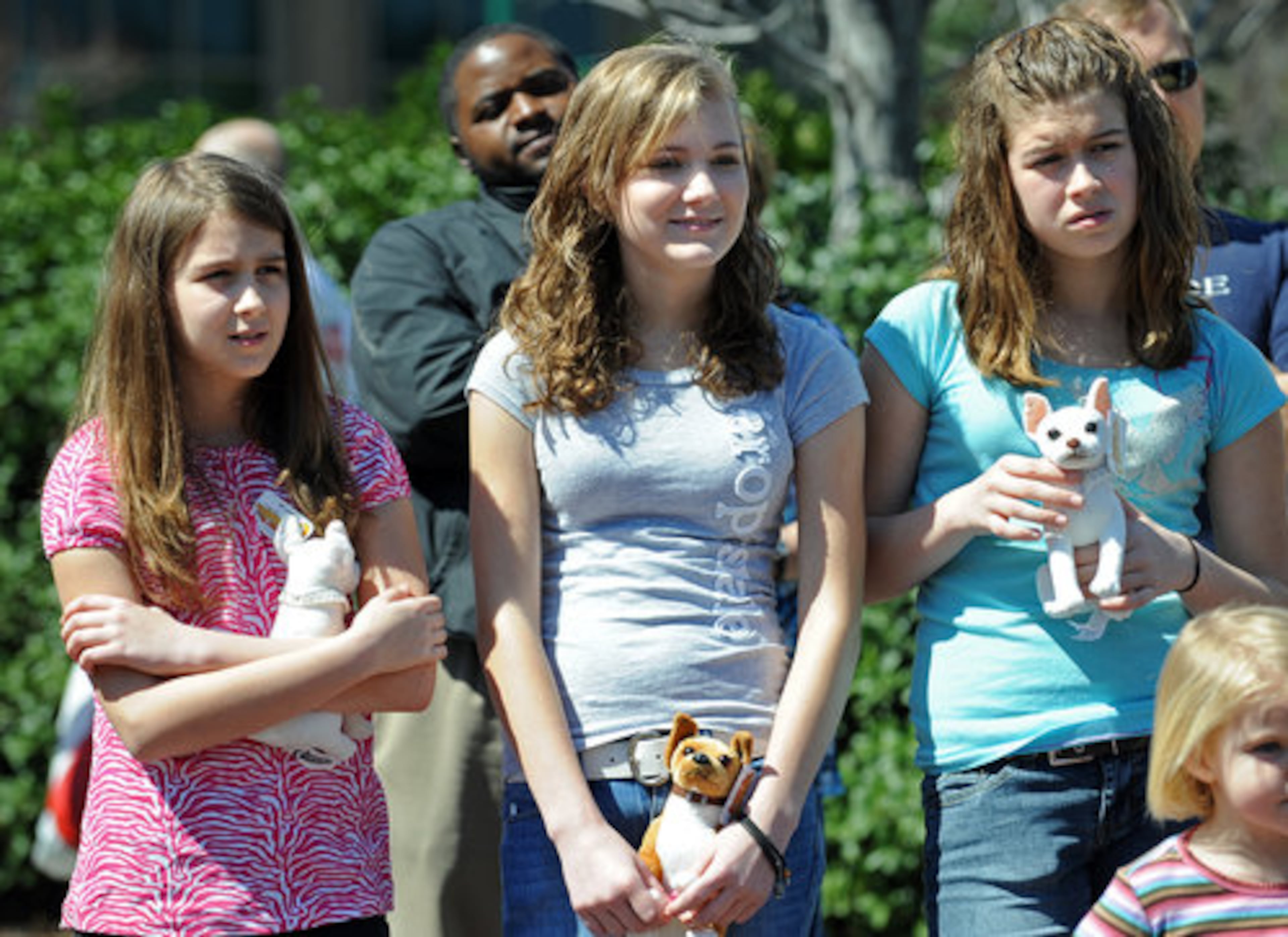 From left, Grace Allen, 11, Heather Wilson, 14, and Grace's sister Kennedy Allen, 13, watch as they hold dog dolls during the first round of the audition.