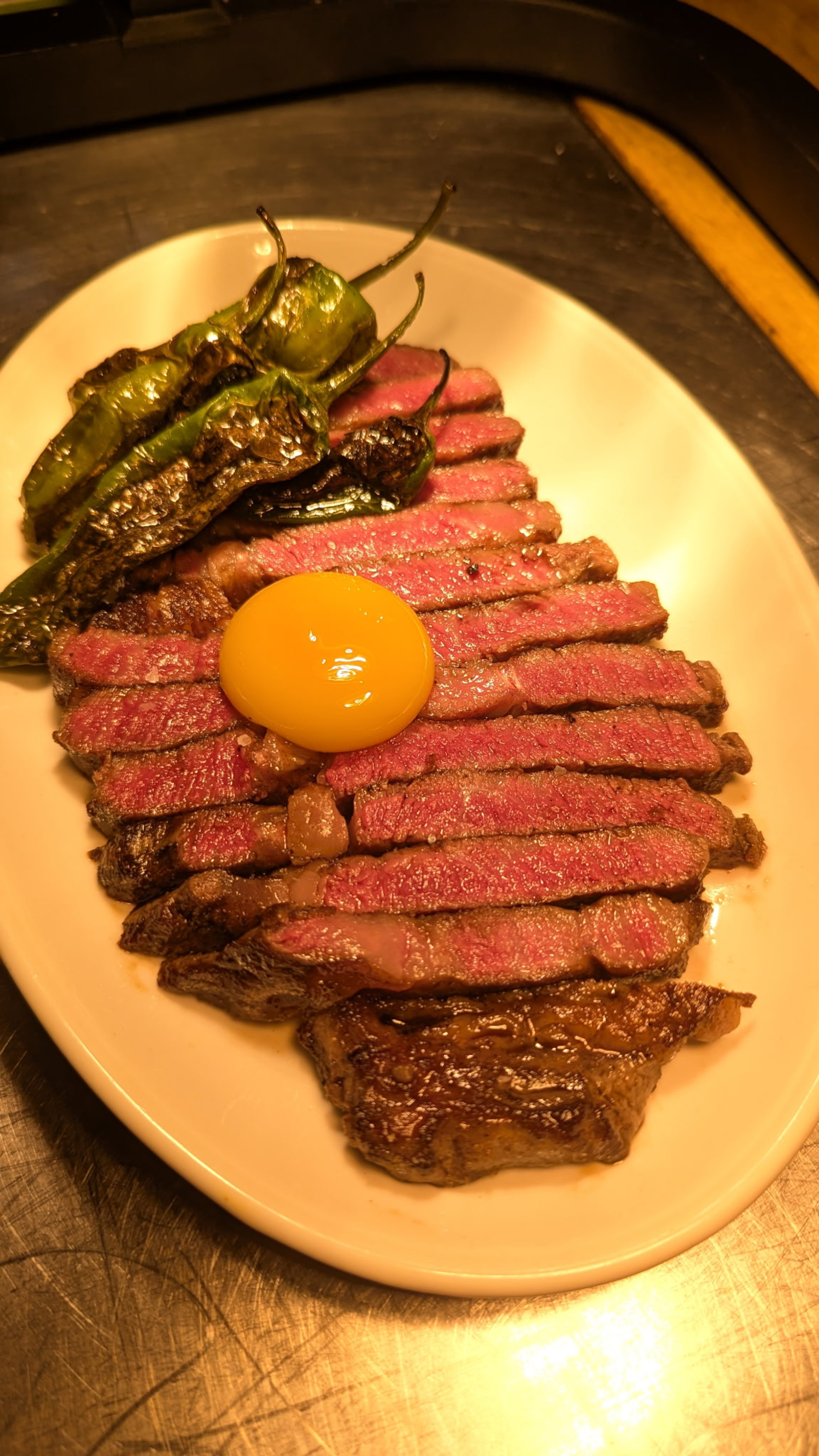 So So Fed’s Australian 6/7 wagyu rib-eye, confit farm egg yolk and blistered Diamond Hill shishito. (Courtesy of Molli Voraotsady)