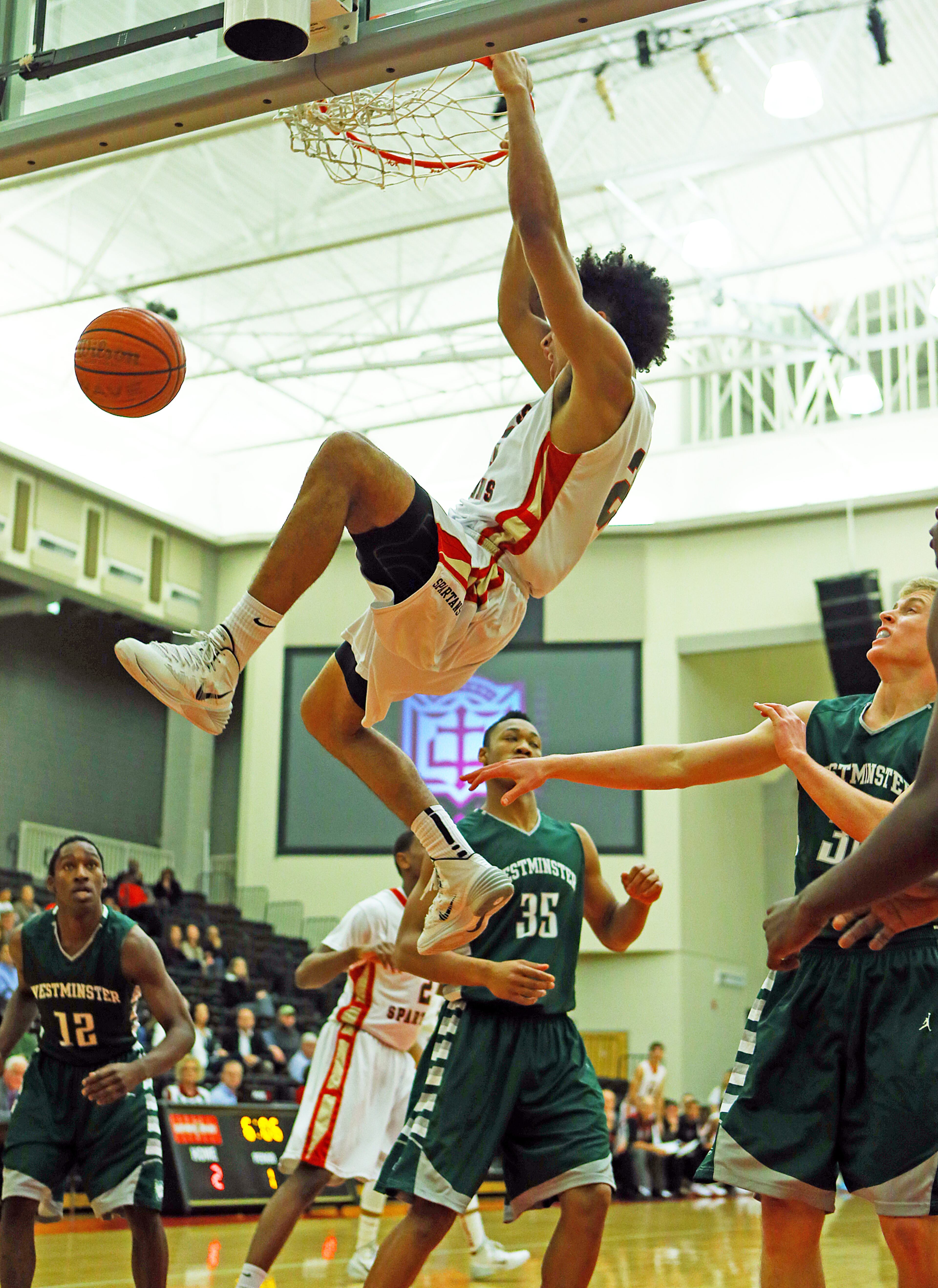 GAC Spartans Isaiah Wilkins gets through a Westminster Wildcats triple team for a slam on the way to a 71-18 victory in their high school basketball game at Greater Atlanta Christian High School on Tuesday, Jan. 14, 2014, in Norcross.
