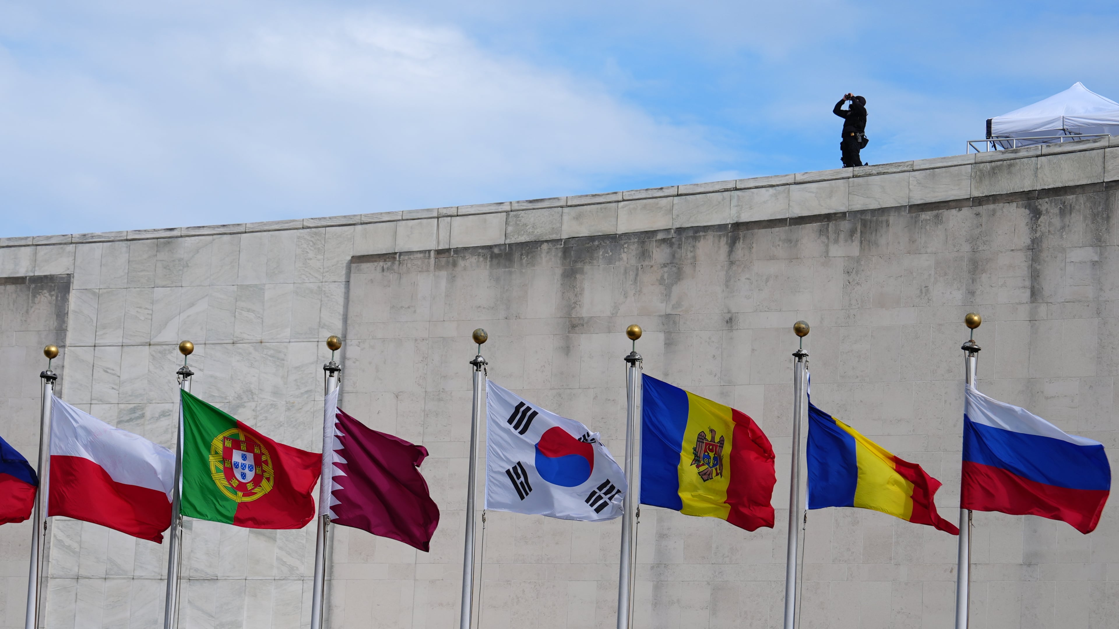 Flags fly at the United Nations Tuesday, Sept. 22, 2026, at the UN headquarters, as security keeps watch. (AP Photo/Julia Demaree Nikhinson)