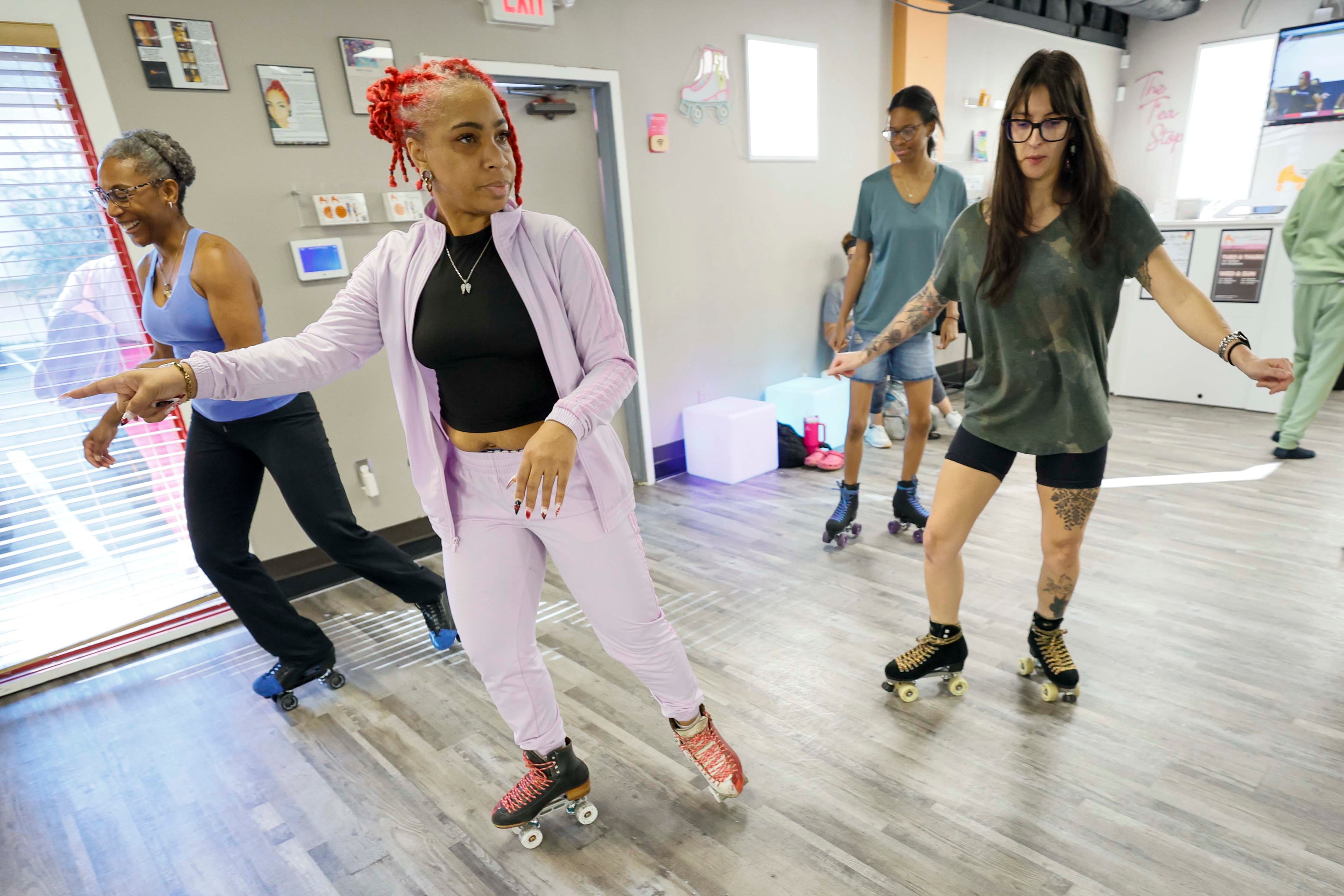 Instructor Gloria Downs, “Coach Glo,” center, gives directions to intermediate students, including Jartu Toles (left) and Megan Williams (right), during a boot camp class at the RollerFit studio in Atlanta on Sunday, Sept. 27, 2026. Downs has roller-skated for about 26 years and is an RSA-certified instructor. (Miguel Martinez/AJC)