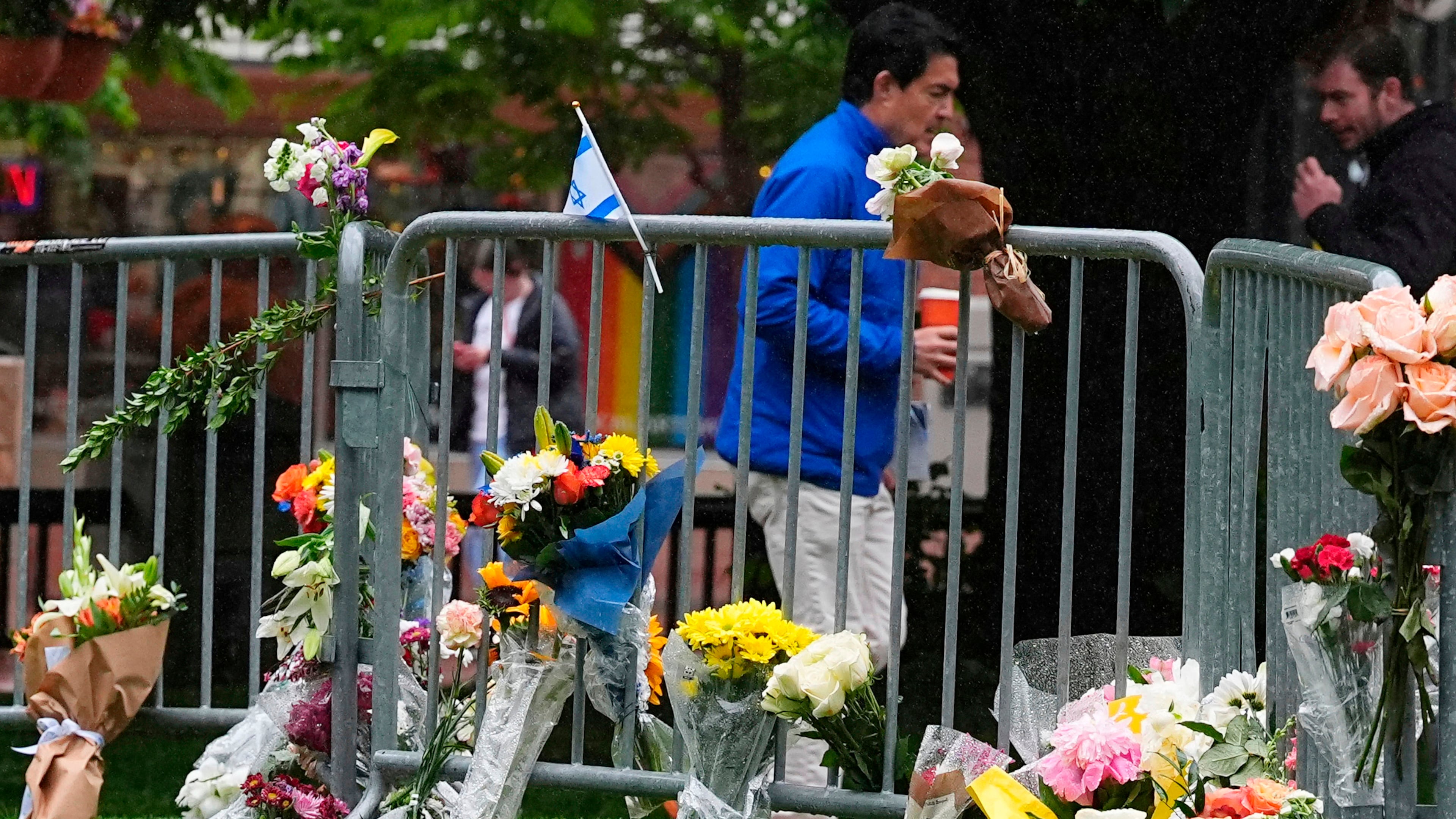 FILE - Bouquets of flowers stand along a makeshift memorial for victims of an attack outside of the Boulder County courthouse on June 3, 2025, in Boulder, Colo. (AP Photo/David Zalubowski, file)