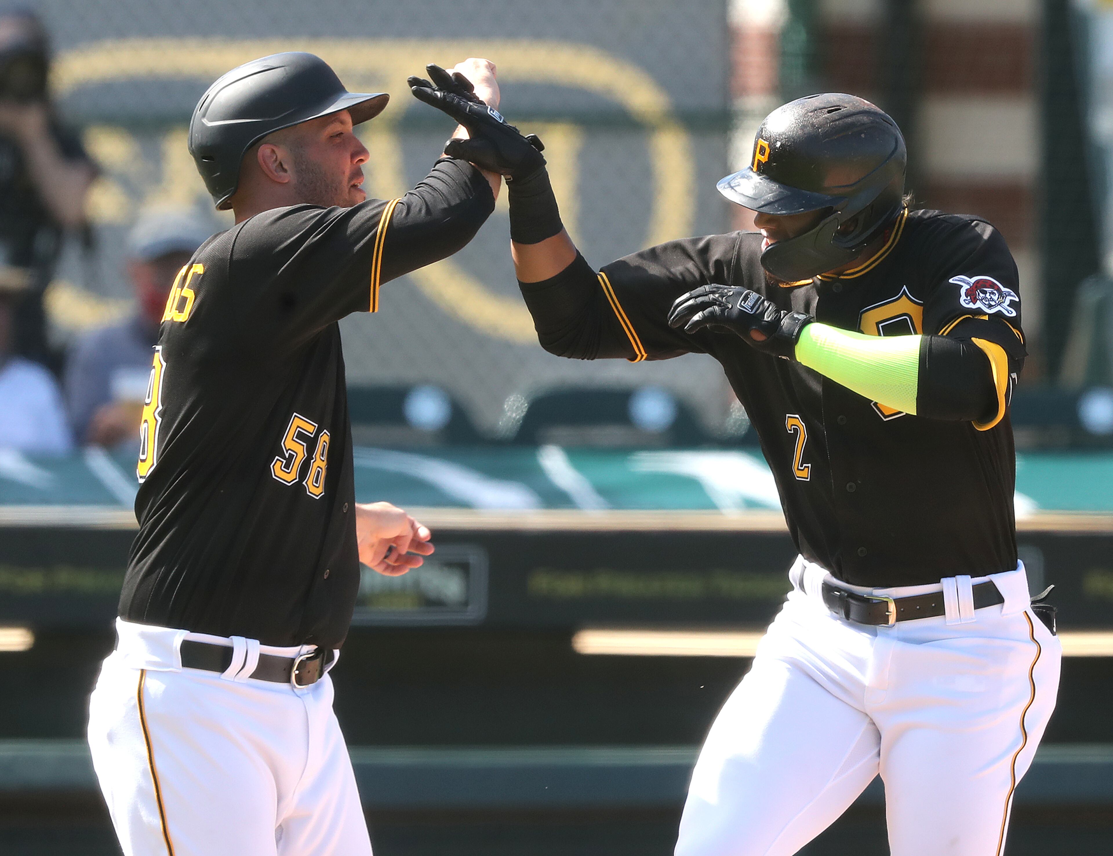 Pirates' Erik Gonzalez (right) celebrates his 2-RBI home run with teammate Jacob Stallings (left) to take a 3-1 lead. “Curtis Compton / Curtis.Compton@ajc.com”