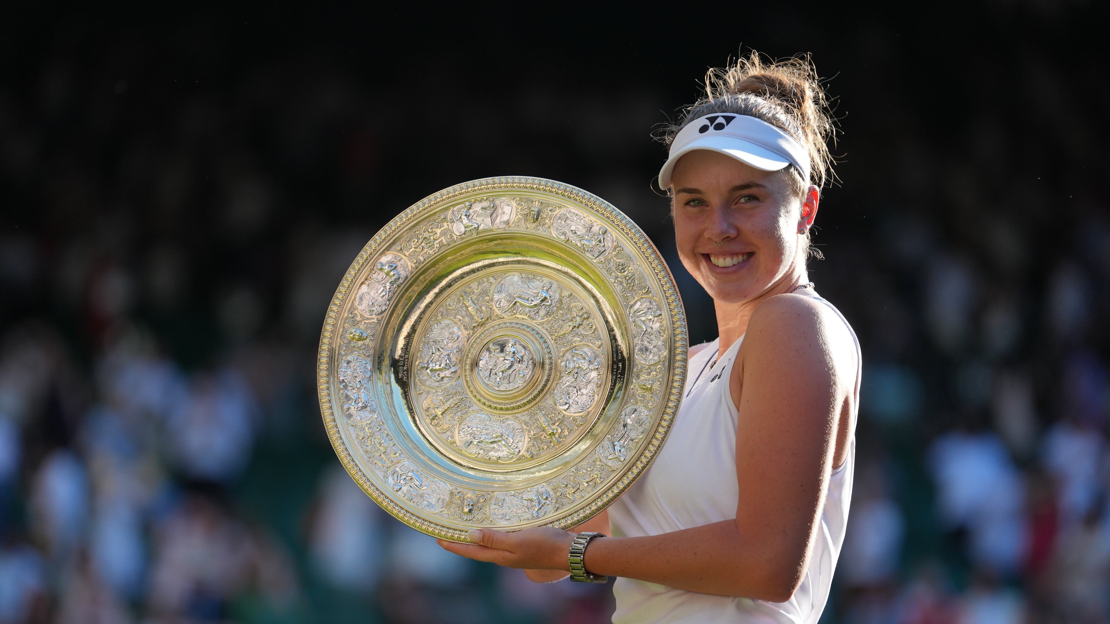 Linda Noskova of Czech Republic poses with the trophy after winning against Karolina Muchova of Czech Republic in the women's singles final at Wimbledon Tennis Championships in London, Saturday, July 11, 2026. (AP Photo/Kirsty Wigglesworth)