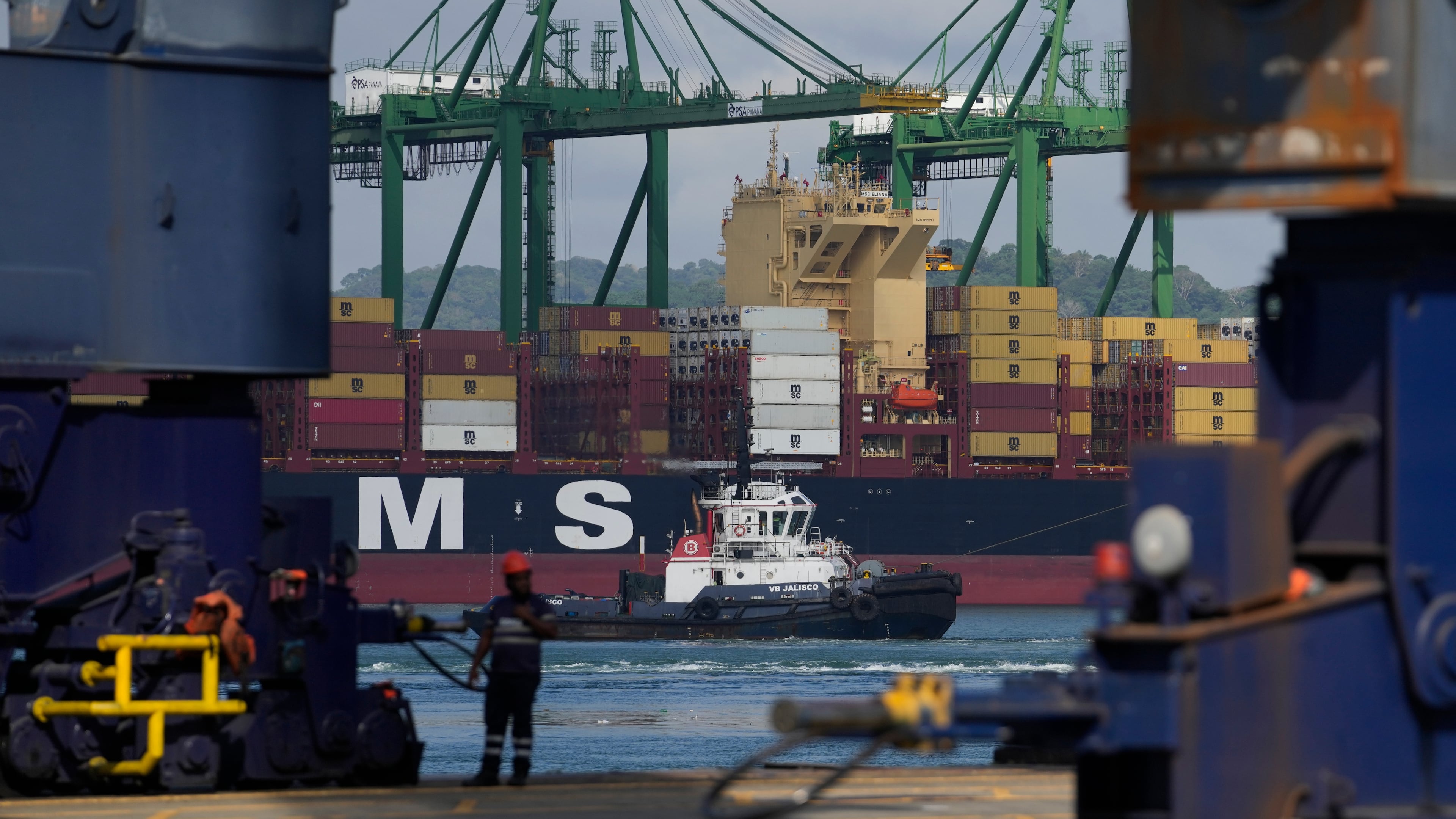 Cranes load and unload containers from cargo ships at the Panama Canal's Rodman Port, operated by PSA International, in Panama City, Thursday, April 9, 2026. (AP Photo/Matias Delacroix)