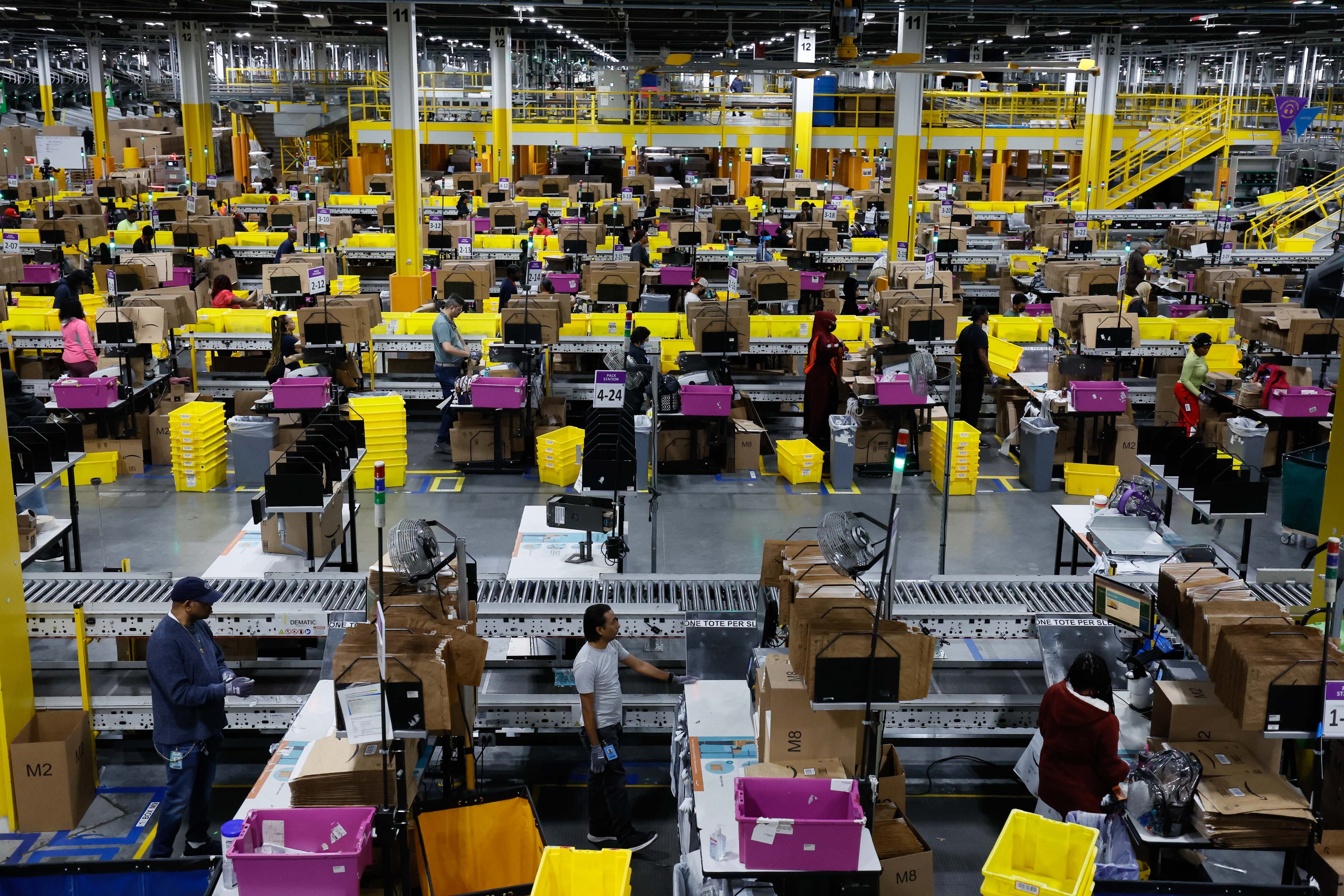 Amazon employees work at the Single Pack Station in Stone Mountain, where packages are prepared for delivery. The world’s largest e-commerce company is seeking taxpayer-backed assistance to transform a southwest Atlanta warehouse into a gigantic package facility. (Miguel Martinez/AJC 2024)