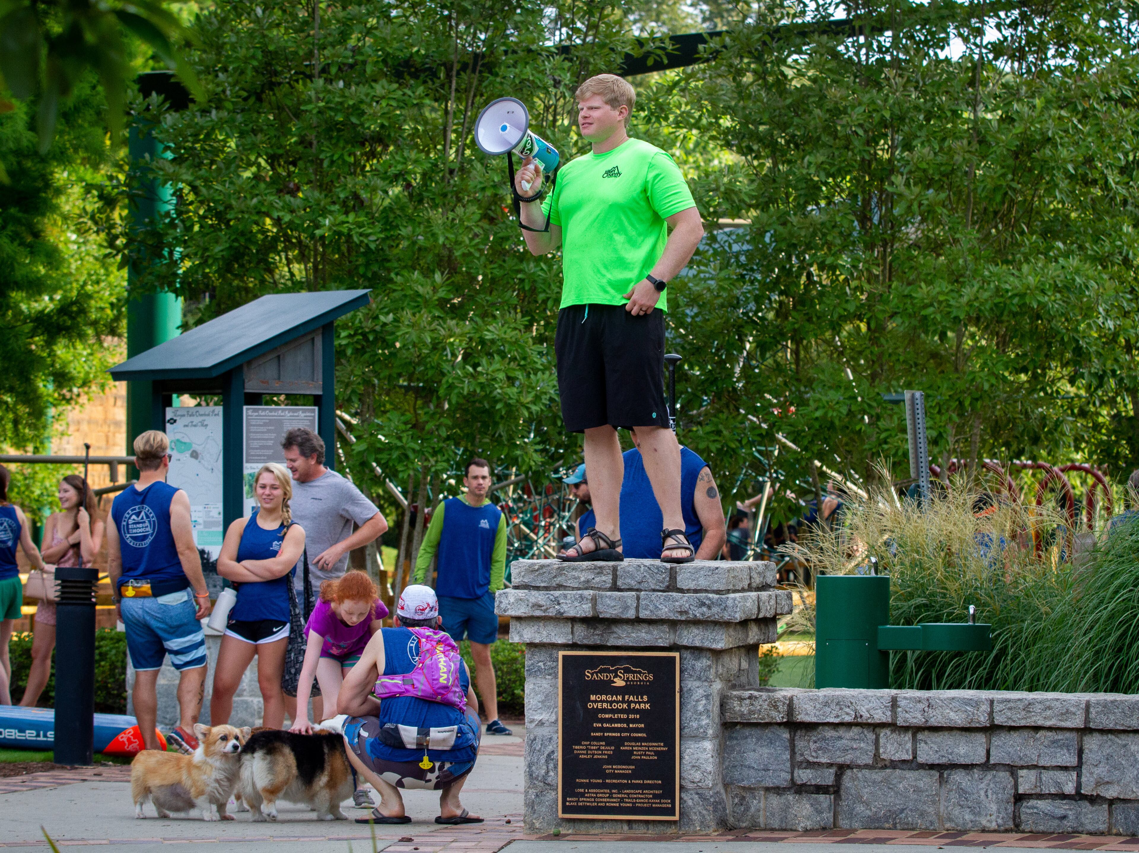 Dan Heller gives instructions to arriving competitors, and spectators, as they enter Morgan Falls Overlook Park before the start of the 8th annual Stand Up for the Hooch at Morgan Falls Overlook Park in Sandy Springs on Sunday, June 23, 2019. STEVE SCHAEFER / SPECIAL TO THE AJC