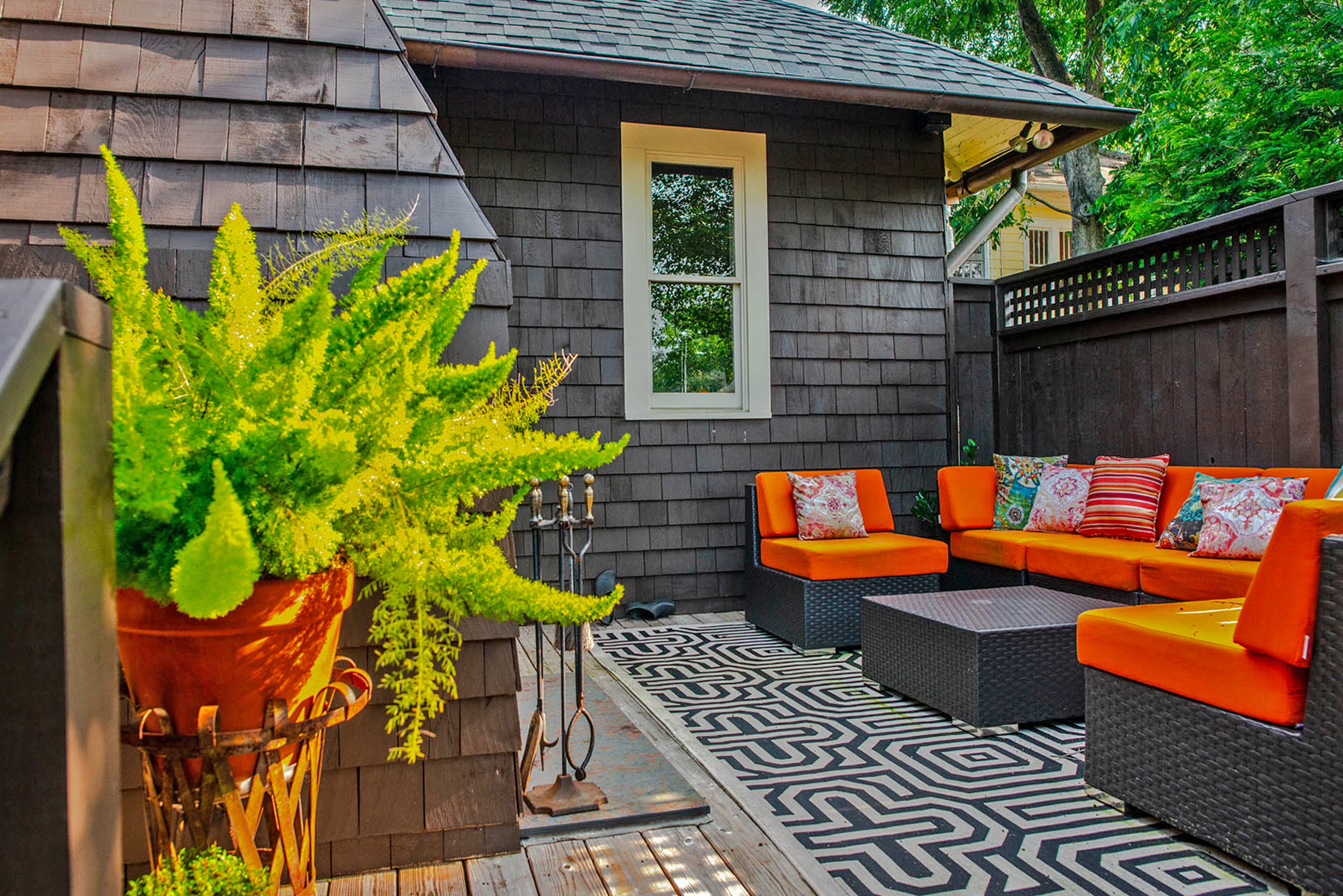 The homeowner restained the Craftsman bungalow's cedar shake exterior, added copper gutters and updated the deck area.