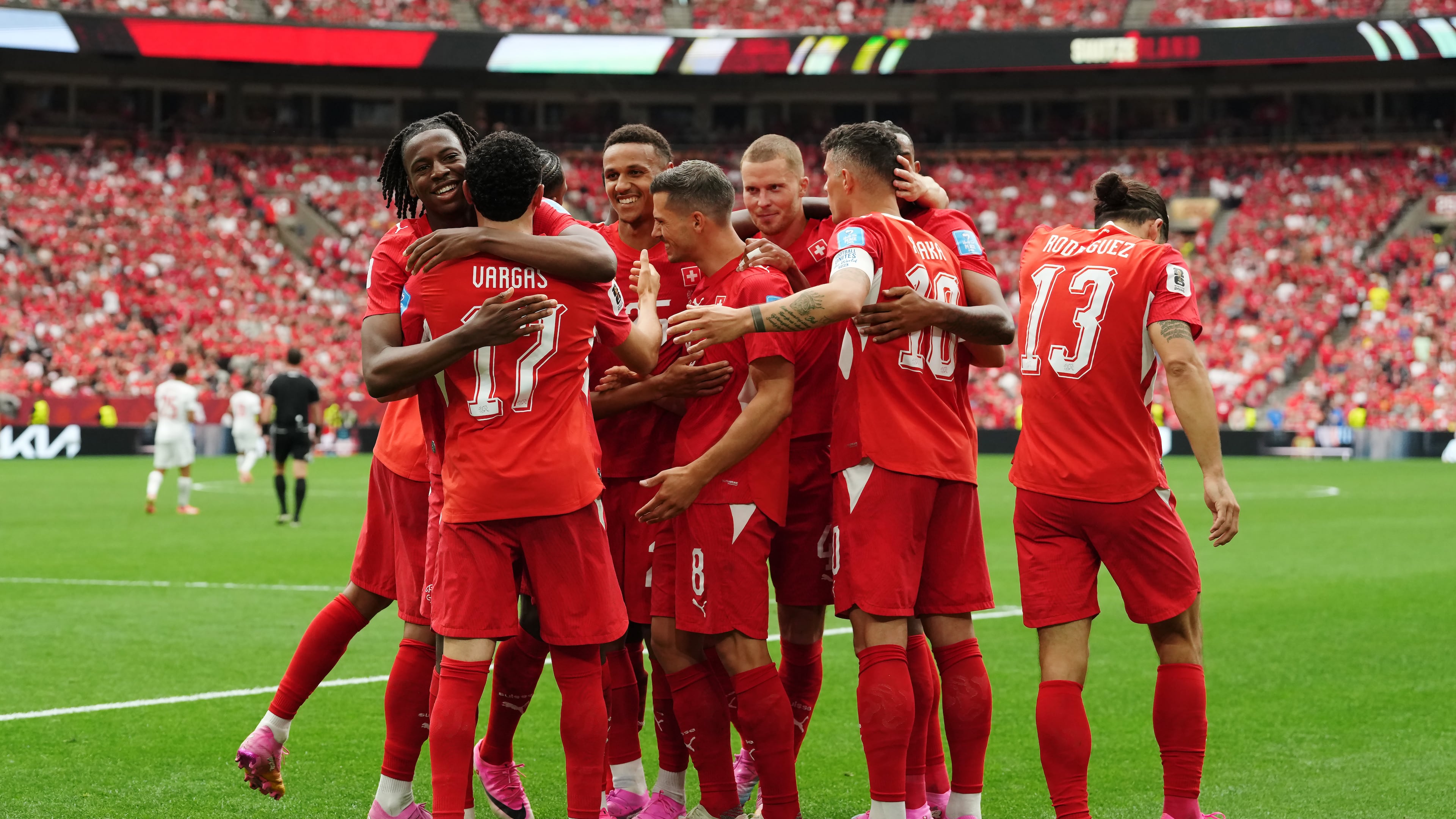 Switzerland's Ruben Vargas (17) is mobbed by teammates after scoring their first goal during the World Cup Group B soccer match between Switzerland and Canada in Vancouver, British Columbia, Wednesday, June 24, 2026. (Ethan Cairns/The Canadian Press via AP)