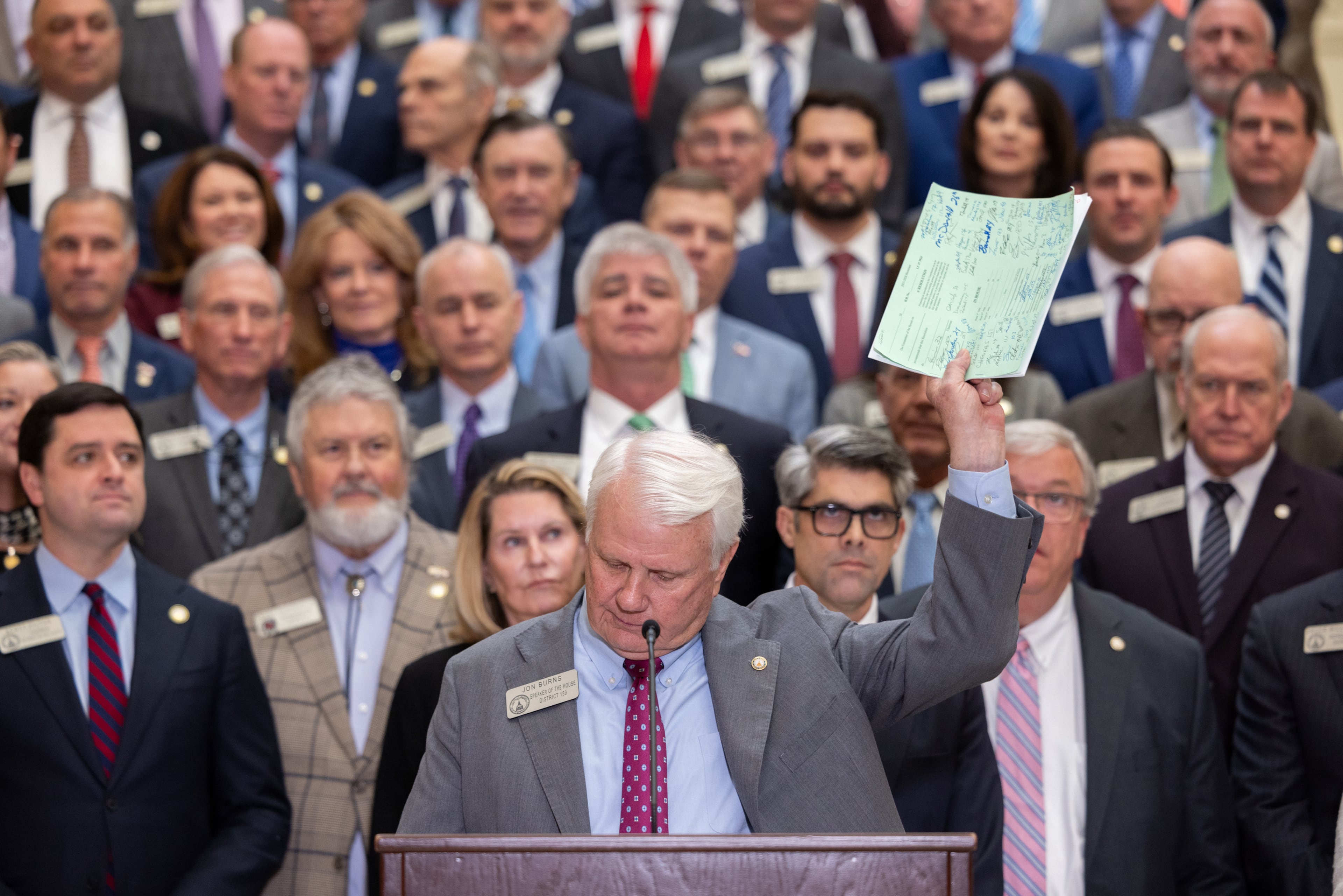 House Speaker Jon Burns holds up proposed property tax relief legislation during a news conference at the Capitol in Atlanta on Wednesday. (Arvin Temkar/AJC)