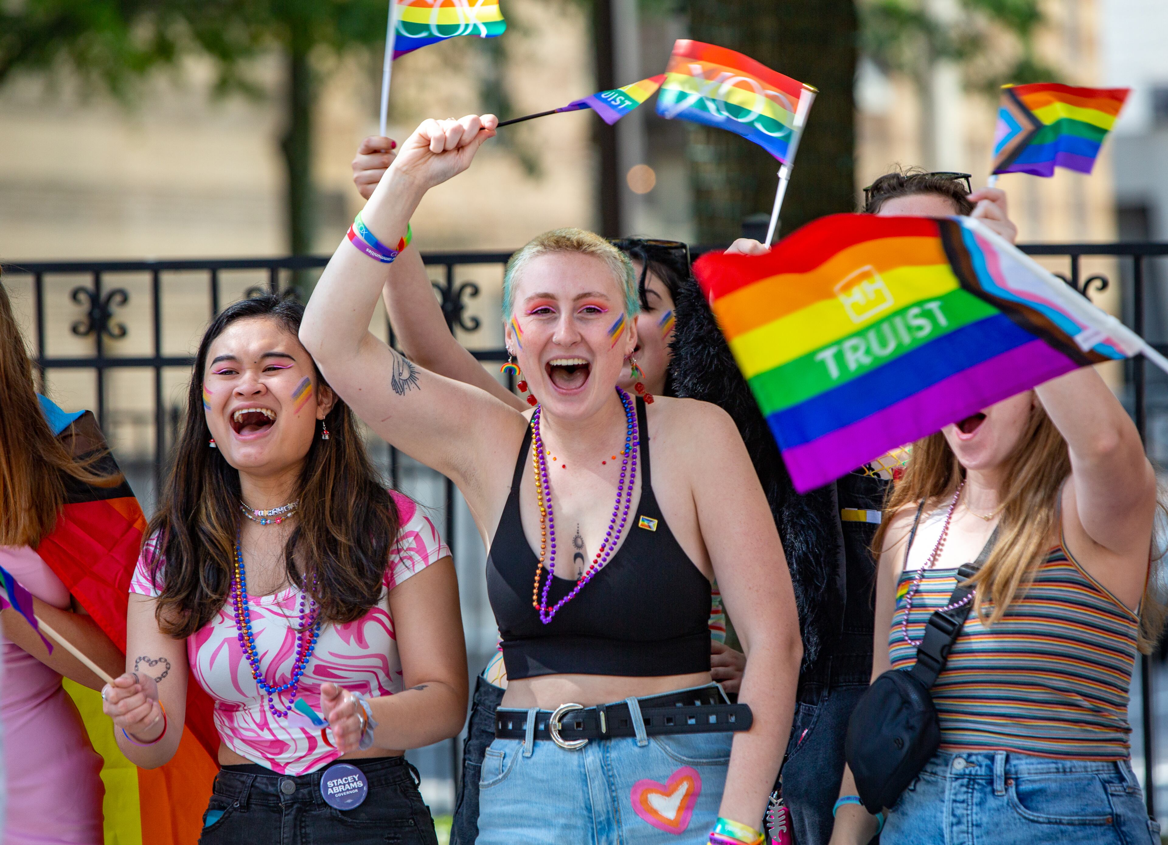 The crowd, including Jessica Down (left) and Kelli Hubinger, celebrates as the Atlanta Pride Parade moves down Peachtree Street toward 10th Street before ending in Piedmont Park on Sunday, Oct. 9, 2022. (Photo: Jenni Girtman for The Atlanta Journal-Constitution)