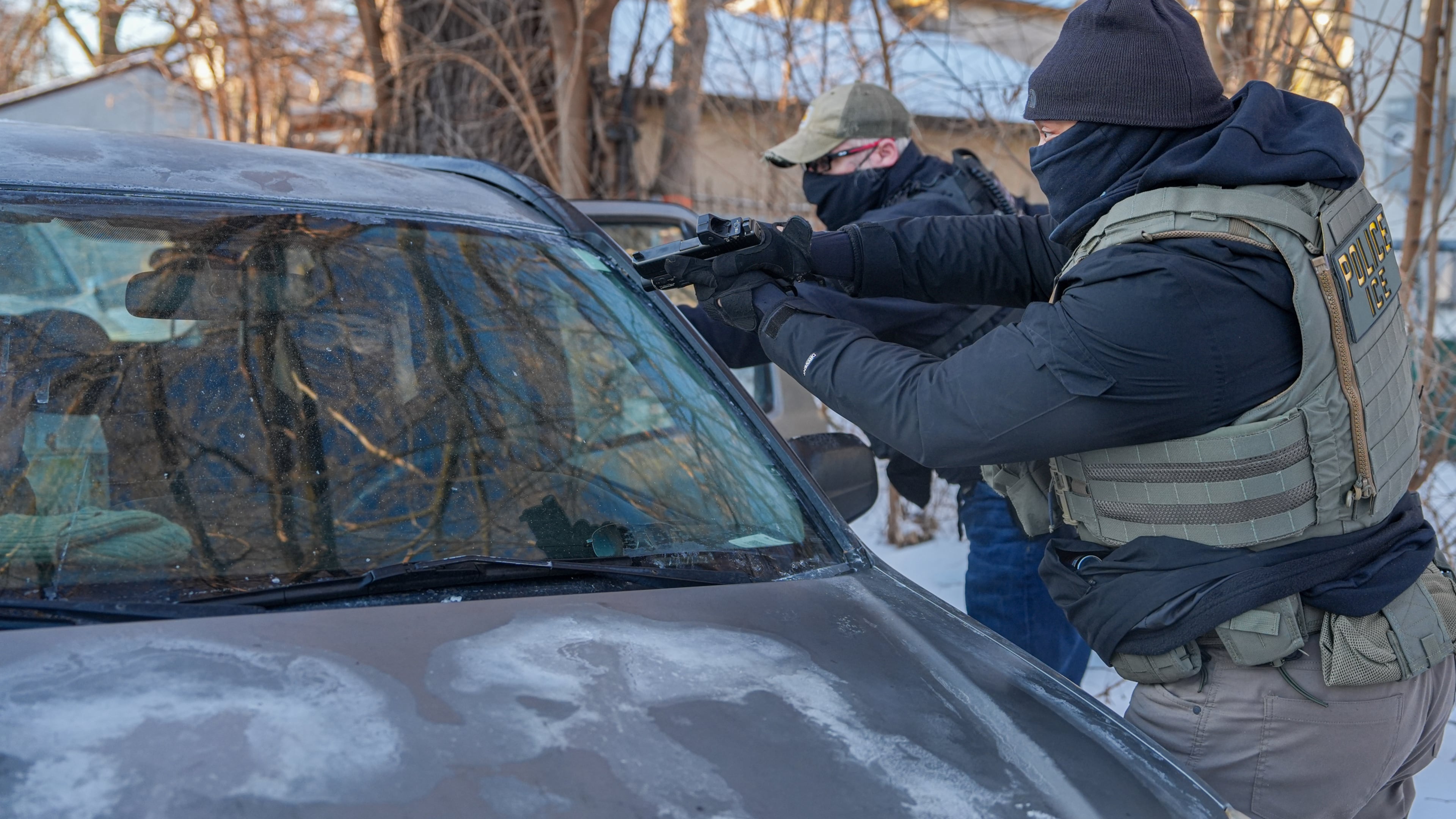 Activists are approached by a federal agent brandishing a firearm, for following agent vehicles, on Tuesday, Feb. 3, 2026, in Minneapolis. (AP Photo/Ryan Murphy)