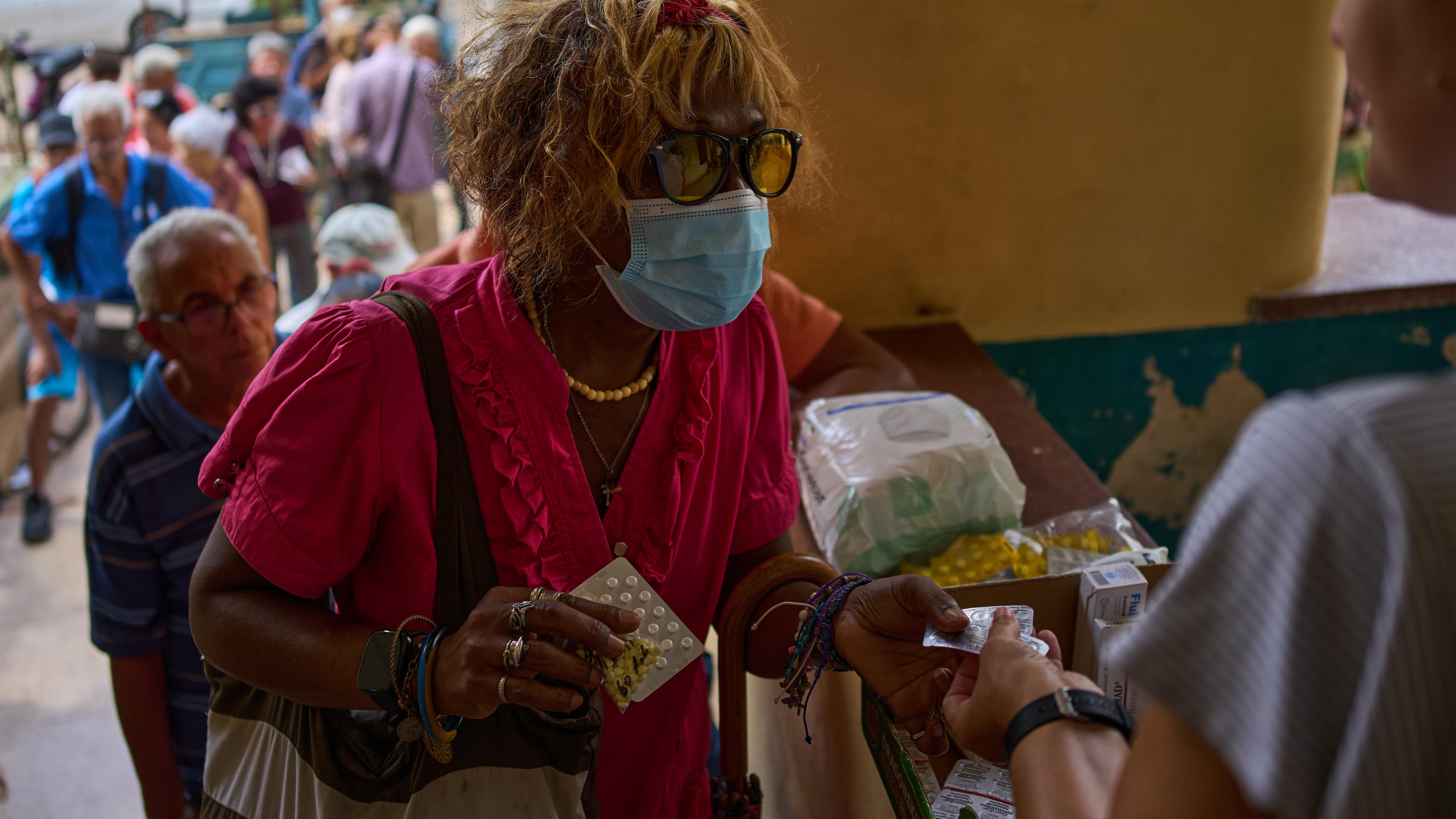 A woman receives medicine distributed through the “Medicine Is Not for Sale” community project in Havana, Cuba, Thursday, Oct. 8, 2026. (AP Photo/Ramon Espinosa)