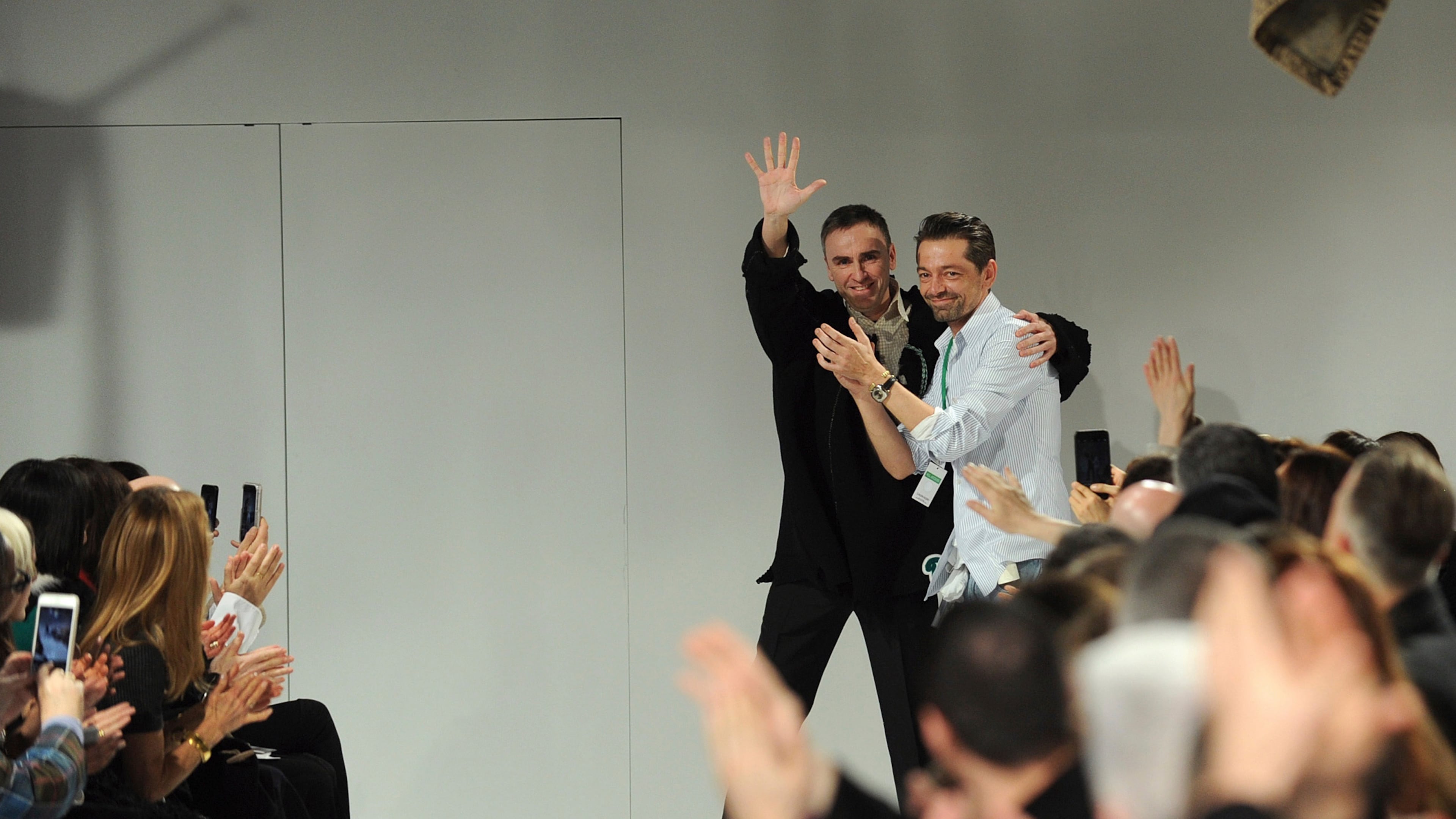 FILE - Raf Simons, left, chief creative officer, and Pieter Mulier, creative director, greet the audience after presenting their Calvin Klein runway show during Fashion Week in New York, Friday, Feb. 10, 2017. (AP Photo/Diane Bondareff, File)