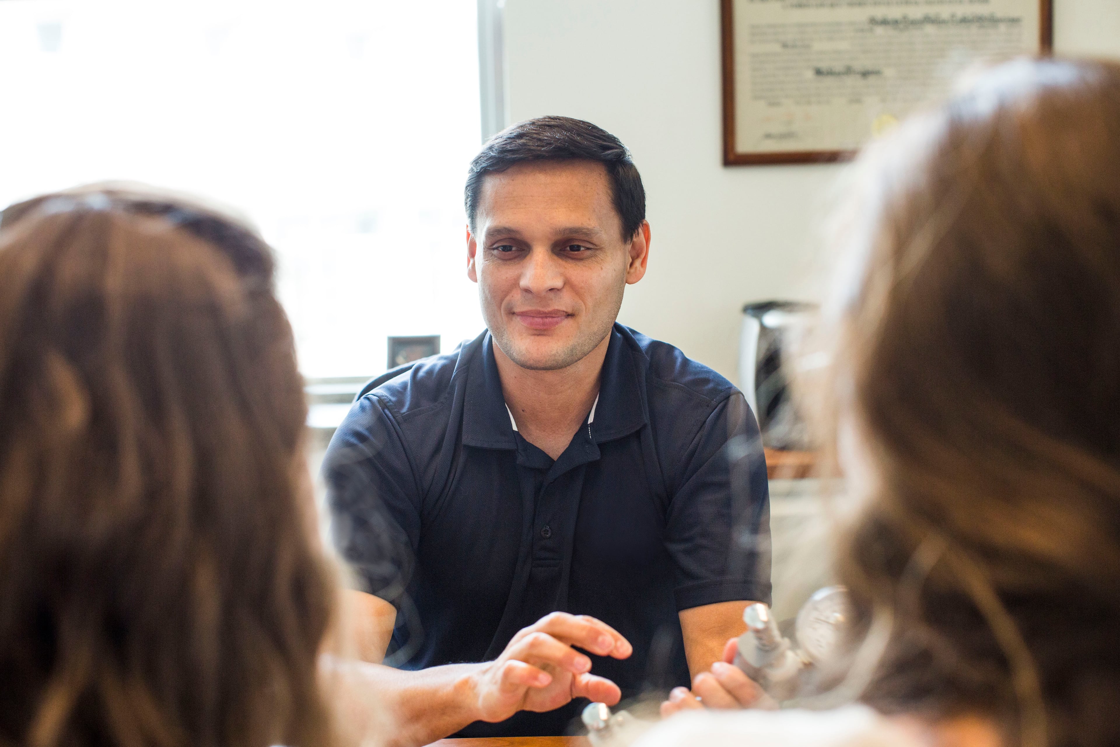 Rollins School of Public Health professor Felipe Lobelo speaks with Sara Hanson and Moriah Bellissimo, two Ph.D. students in the nutrition program at the Dept of Global health at the School of Public Health. (Courtesy of Emory University)