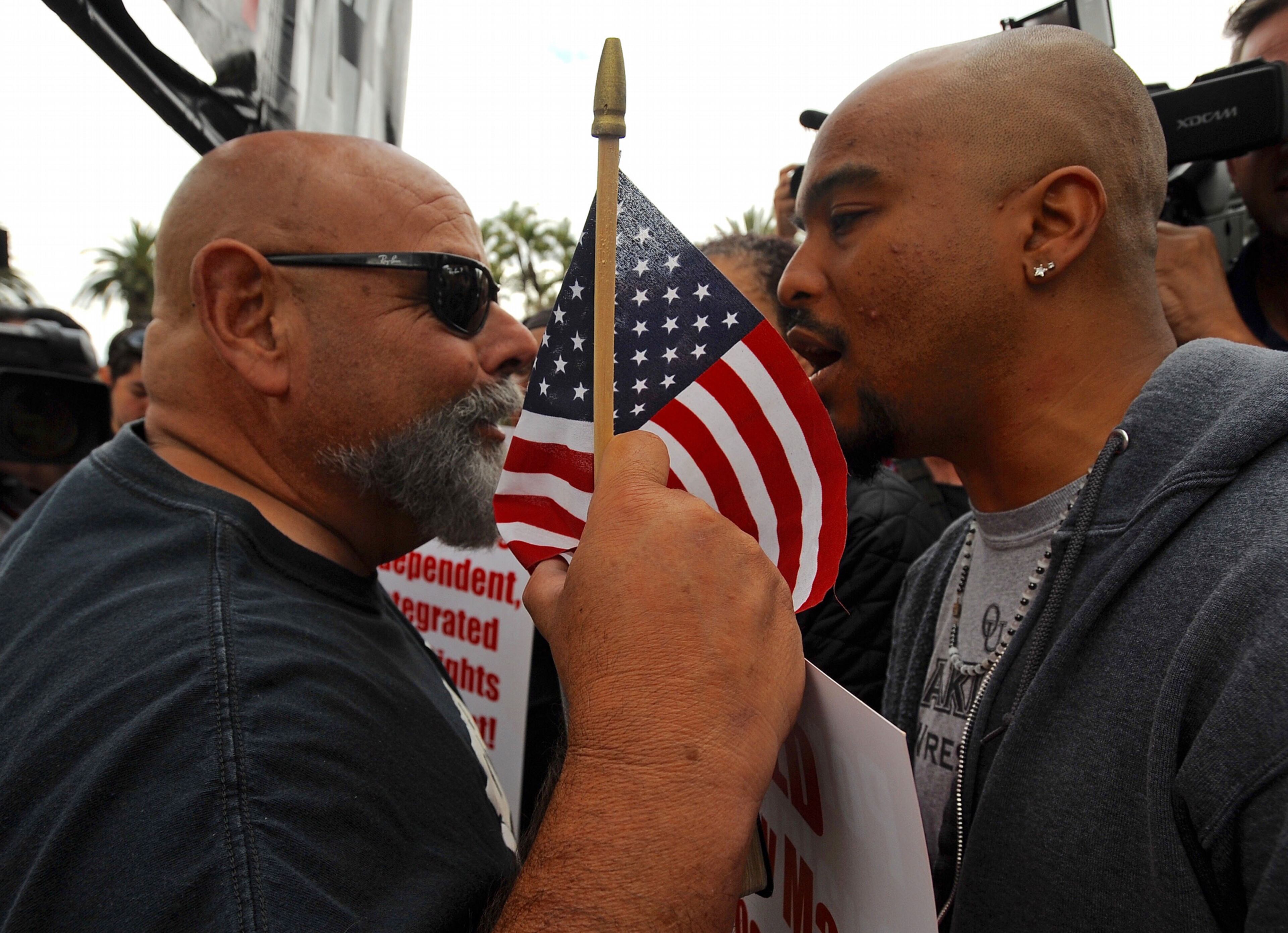 Protesters face-off outside a Donald Trump rally at the Anaheim Convention Center on Wednesday, May 25, 2016 in Anaheim, Calif. A small but vocal group of people protested outside a Donald Trump campaign rally Wednesday in Orange County amid a heavy police presence to guard against a repeat of raucous demonstrations at other Trump events. (Michael Goulding /The Orange County Register via AP)