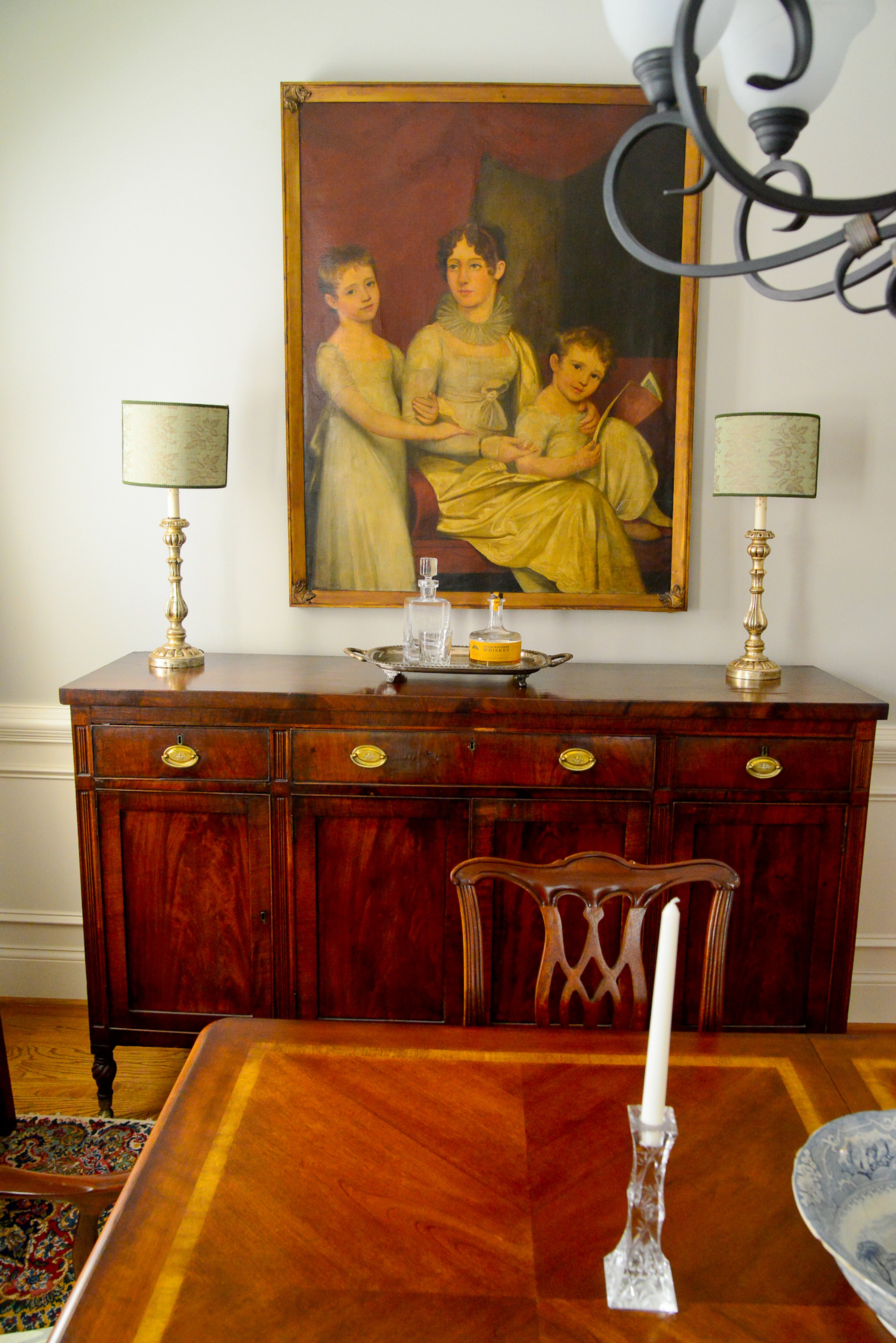 The early American sideboard is one of the oldest pieces in homeowner Chris Schroder's family, passed down through generations. The painting above it also belonged to his mother.