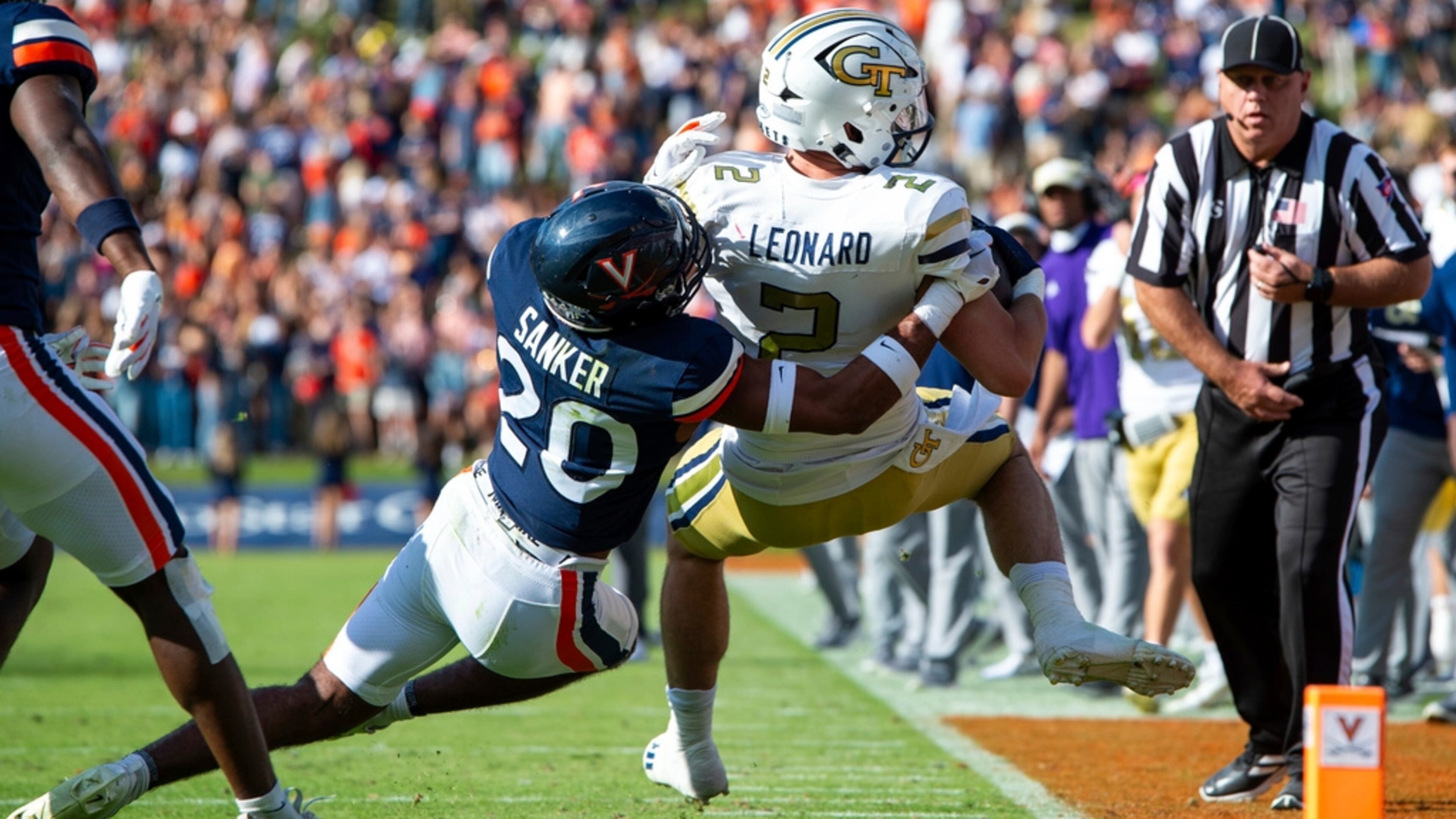 Georgia Tech tight end Dylan Leonard (2) is brought down by Virginia safety Jonas Sanker (20) during the first half of an NCAA college football game Saturday, Nov. 4, 2023, in Charlottesville, Va. (AP Photo/Mike Caudill)