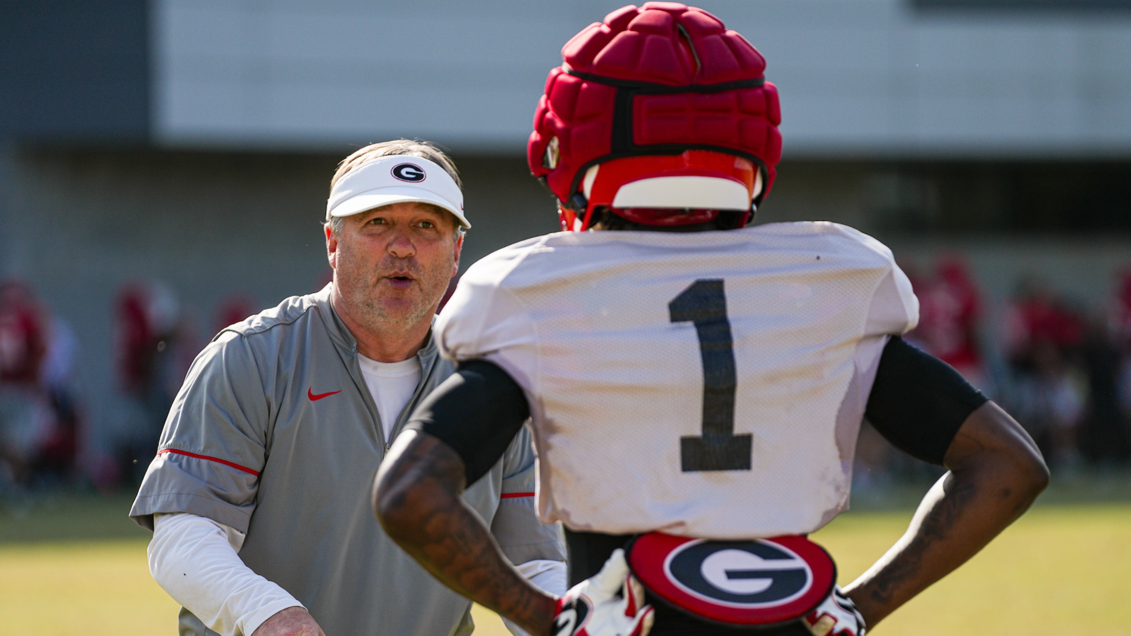 Georgia coach Kirby Smart talks to cornerback Ellis Robinson during a spring practice. Smart is 1-4-1 against the spread at home when favored by 35 points or more, according to the OddsShark database. (Tony Walsh/UGAAA)