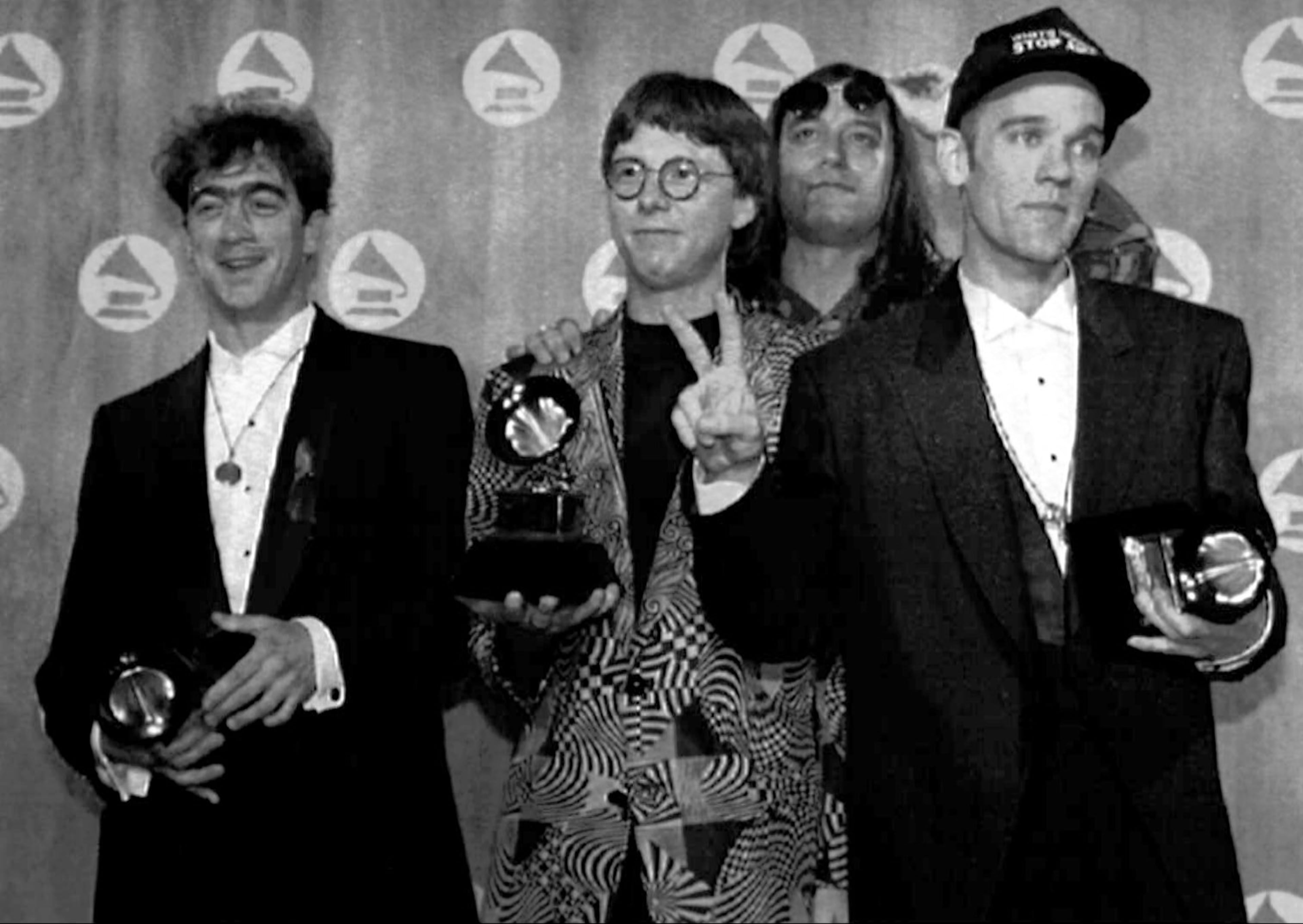 The Music group R.E.M. poses with three Grammys they received at the Grammy Awards in New York, Feb. 25, 1992. They won the best Pop performance by a Duo or Group with Vocal,Best Alternative Music Album for the album "Out of Time" and Best Music Video-Short Form for their song "Losing my Religion."