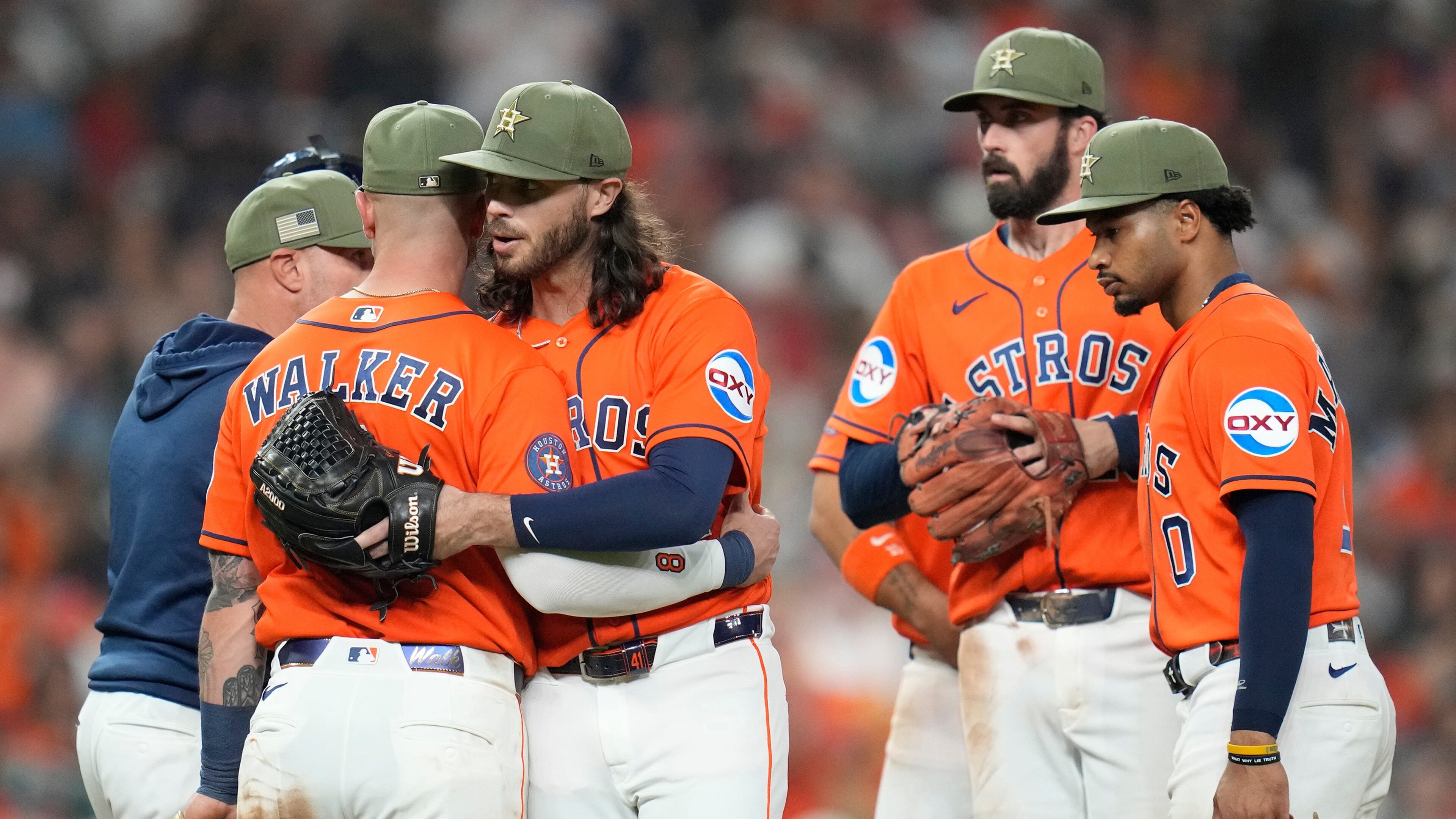 Houston Astros starting pitcher Spencer Arrighetti, center left, hugs Christian Walker after a single by Texas Rangers' Justin Foscue broke up his no-hit bid during the eighth inning of a baseball game, Friday, May 15, 2026, in Houston. (AP Photo/Karen Warren)