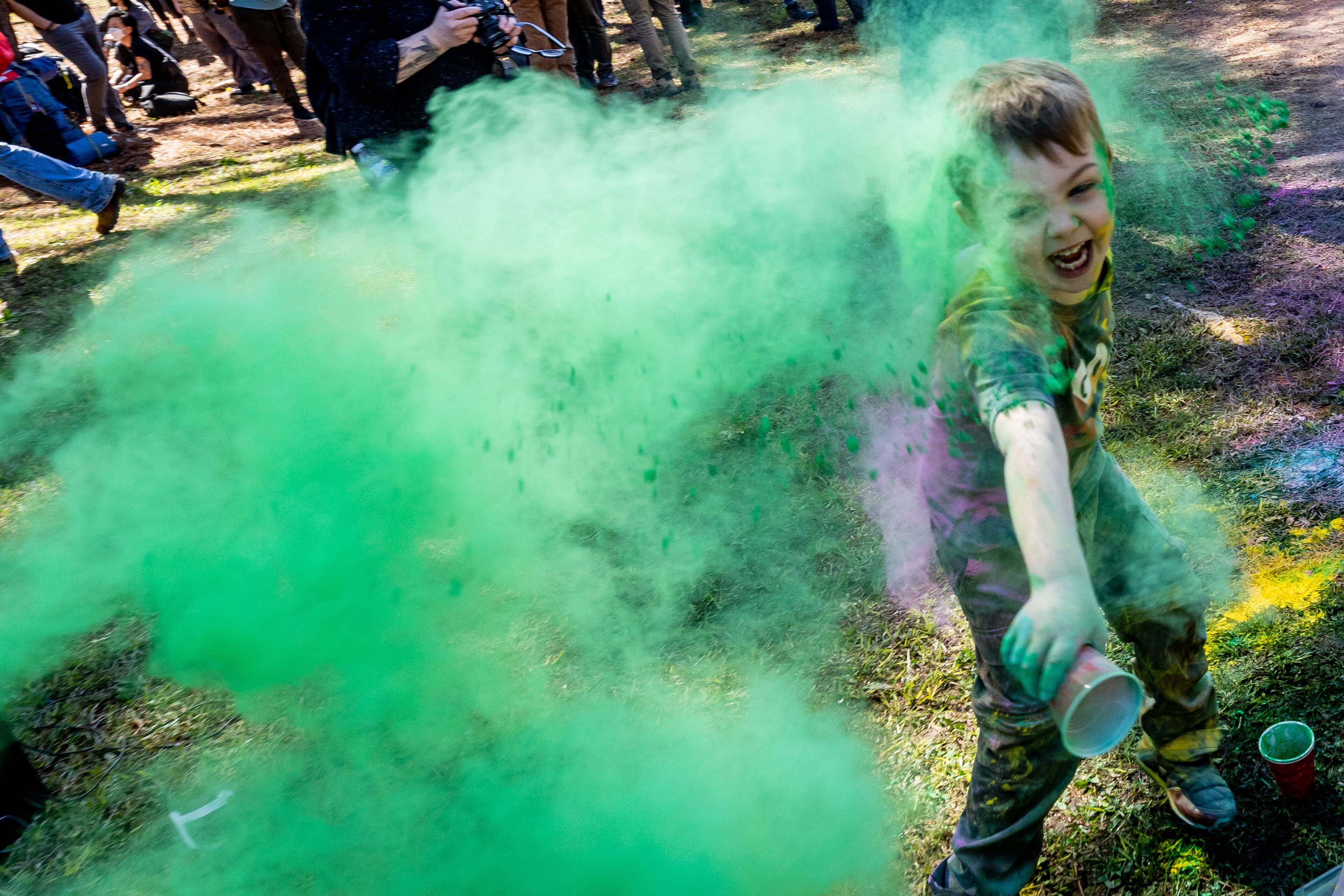 Kids throw colorful powder at the beginning of the Defend the Atlanta Forest and public safety training center protest at Gresham Park in Atlanta on Saturday, March 4, 2023. (Steve Schaefer/steve.schaefer@ajc.com)