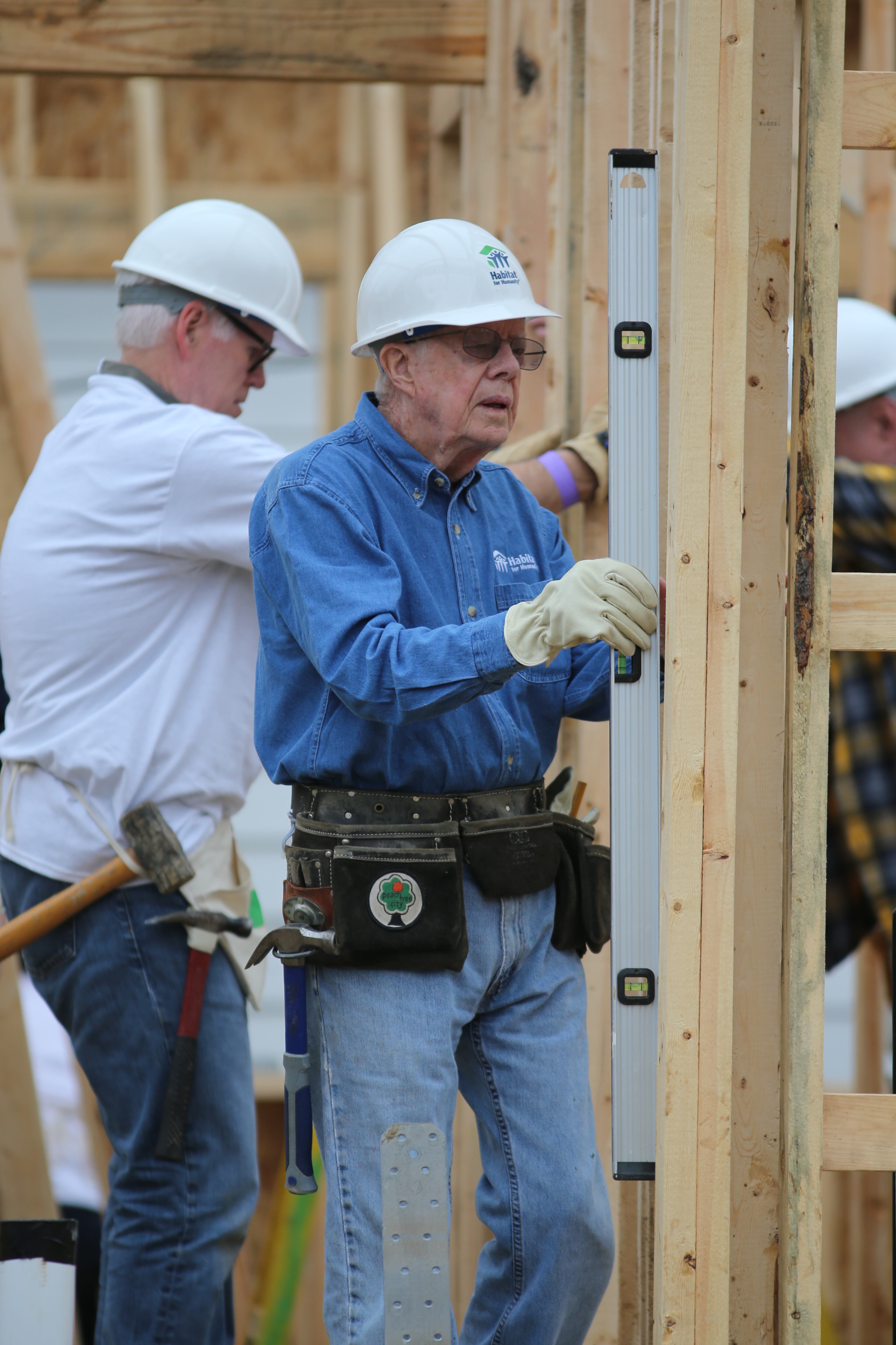 Former President Jimmy Carter and his wife Rosalynn help out on a Habitat for Humanity project on Nov. 2, 2015, in Memphis. The one-day build partnering them with a local family and volunteers is in lieu of a bigger Habitat building project in Nepal that was abruptly cancelled last month. Ben Gray / bgray@ajc.com