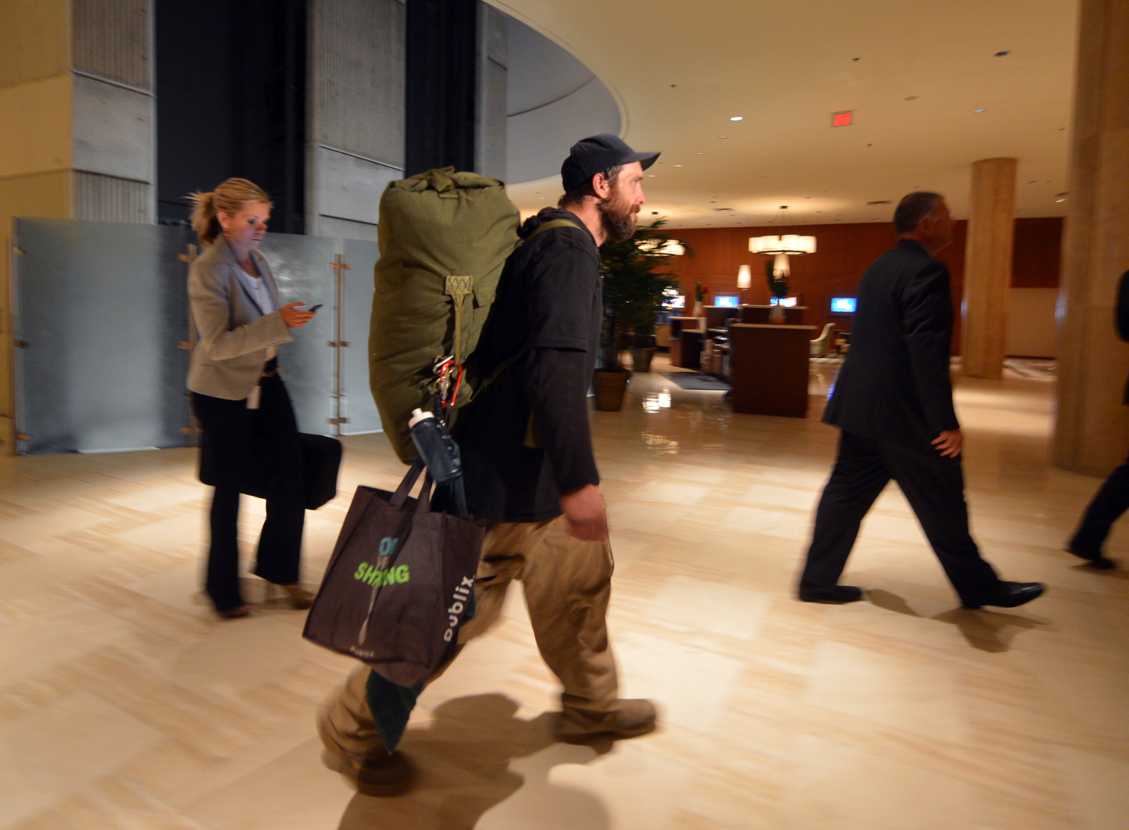 Joel Hartman, who is homeless, walks through the lobby of the Omni Hotel on his way to his room. Hartman turned in a wallet he found while searching for food in a trash can on November 7, 2013. He went to two hotels until he was able to return the wallet to its owner, a woman staying at the Omni Hotel at CNN Center. Recently hotel officials decided to track down the man and offer him a room, food and money.