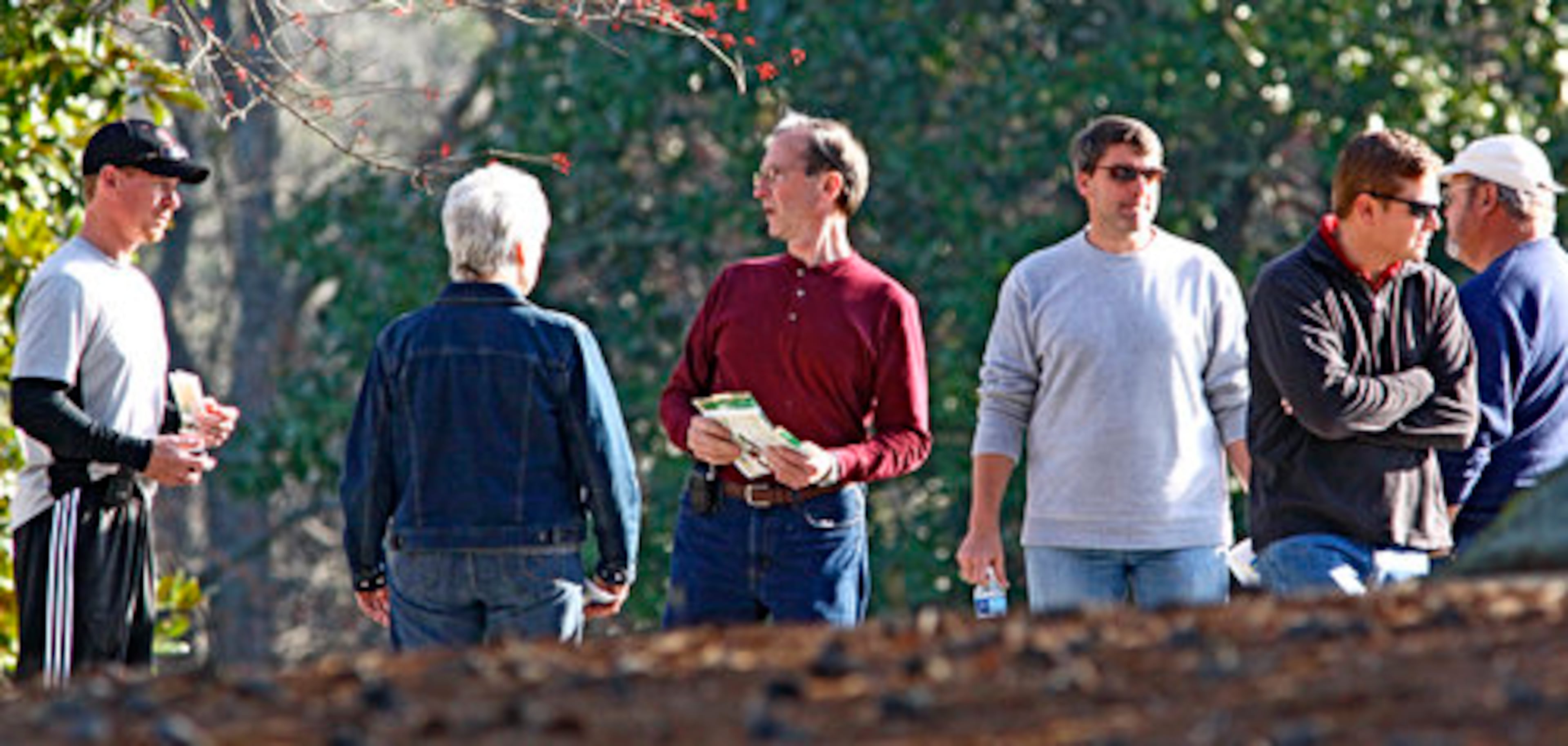 Antony Edge's father, Robert Edge (center) speaks with other search members Wednesday.