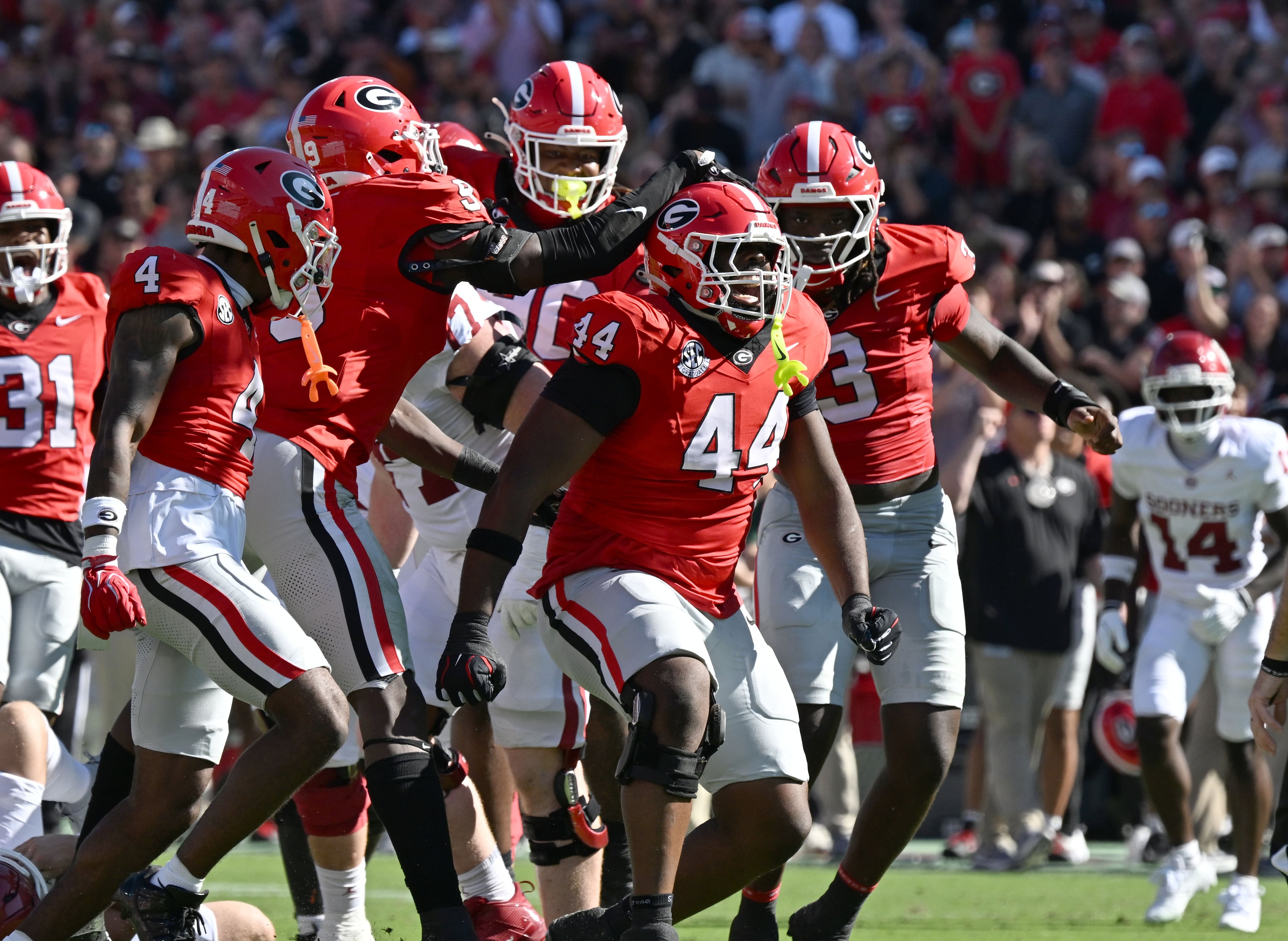 Georgia defensive lineman Jordan Hall (second from right) celebrates after sacking Oklahoma quarterback John Mateer during the first half of an NCAA football game at Sanford Stadium on Saturday, Sept. 26, 2026, in Athens, Ga. (Hyosub Shin/AJC)