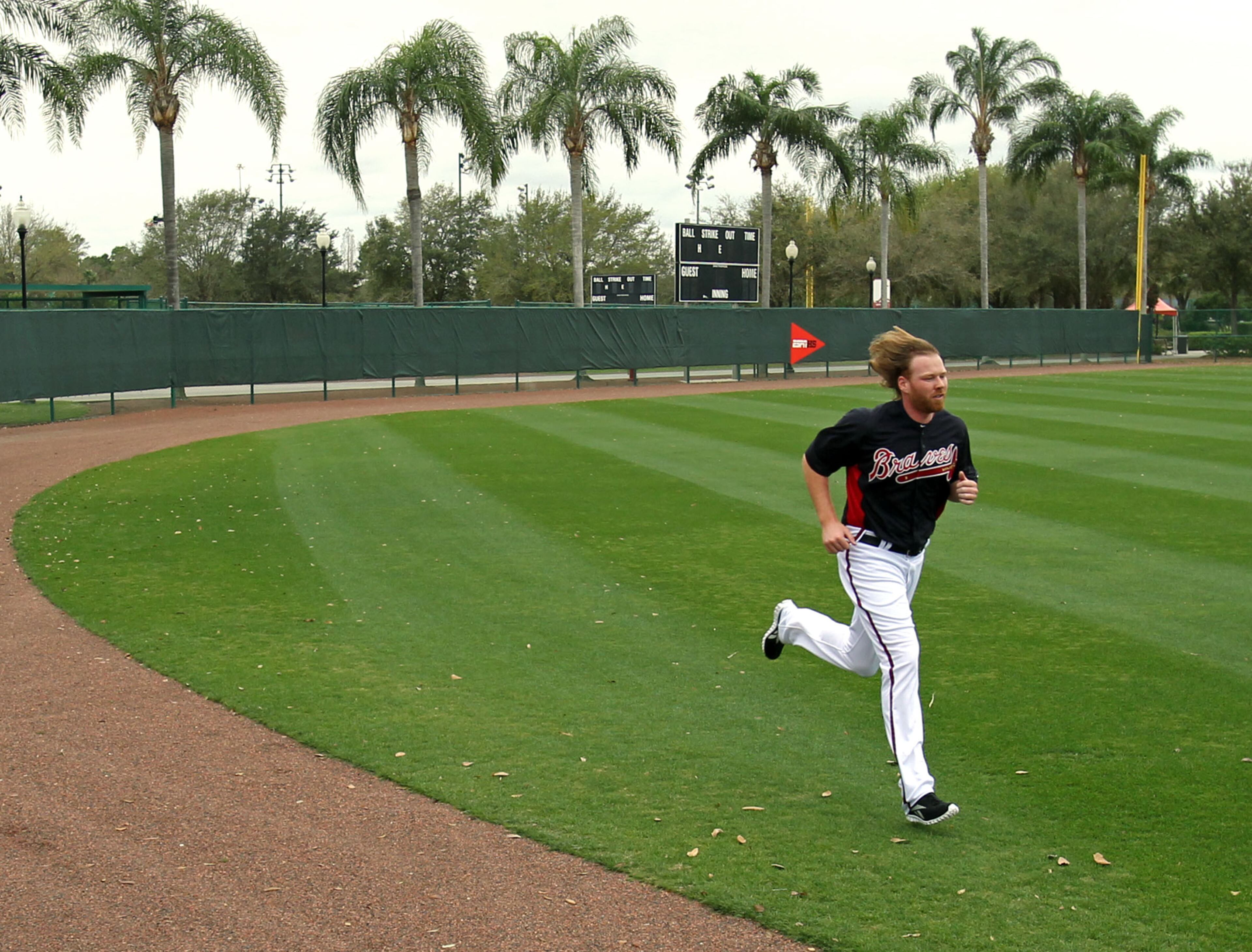 Atlanta Braves pitcher Tommy Hanson runs around the warning track of the outfield during the second full squad workout at Champion Stadium in the ESPN Wide World of Sports Complex in Lake Buena Vista, Fl., Feb. 26, 2012. Hanson is recovering from a concussion from a one-car accident early Monday morning Feb. 20, 2012. Hanson ran and threw some for the first time during workouts. Jason Getz jgetz@ajc.com