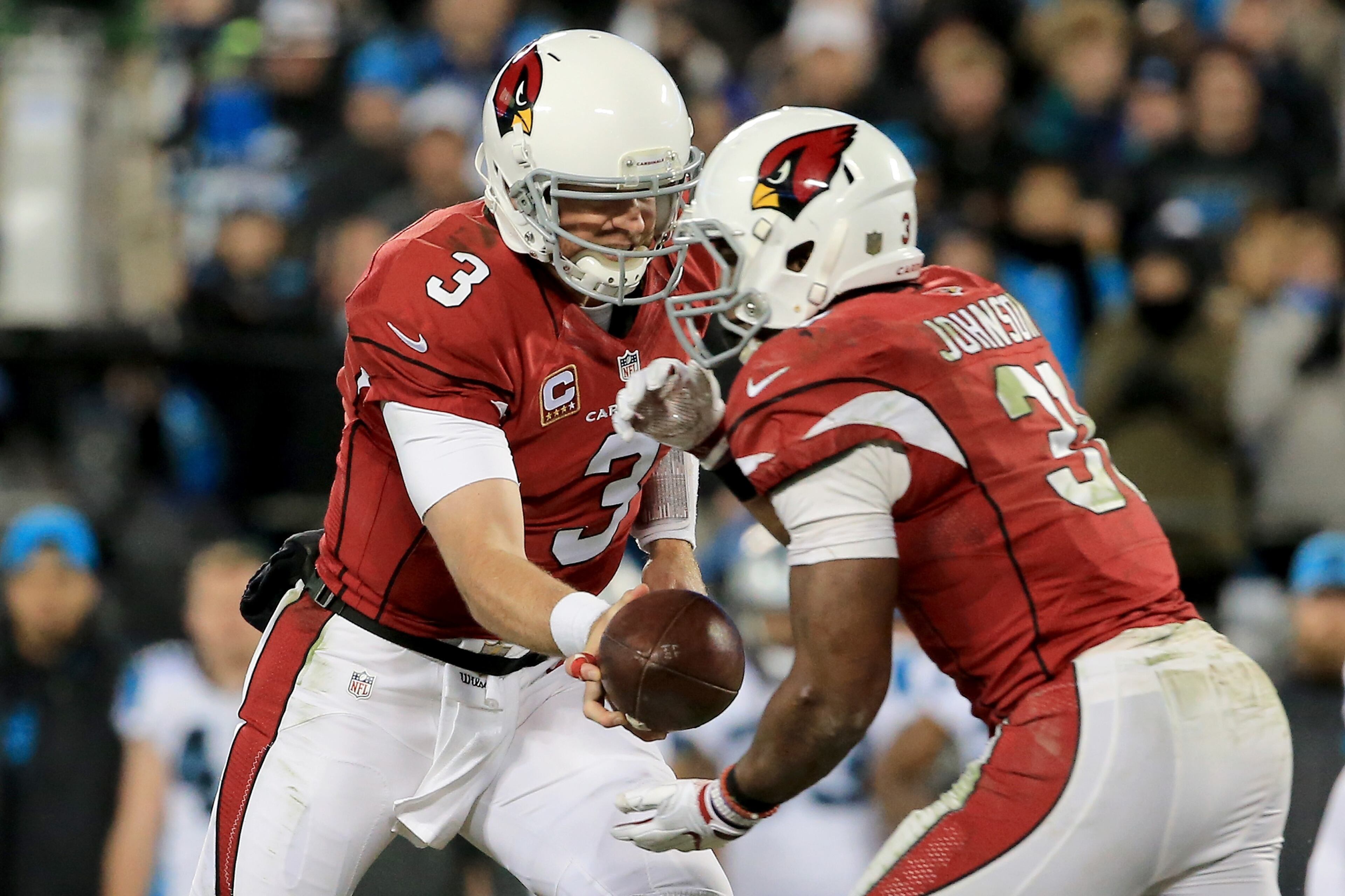 CHARLOTTE, NC - JANUARY 24: Carson Palmer #3 of the Arizona Cardinals hands the ball off to David Johnson #31 in the second half against the Carolina Panthers during the NFC Championship Game at Bank of America Stadium on January 24, 2016 in Charlotte, North Carolina. (Photo by Mike Ehrmann/Getty Images)