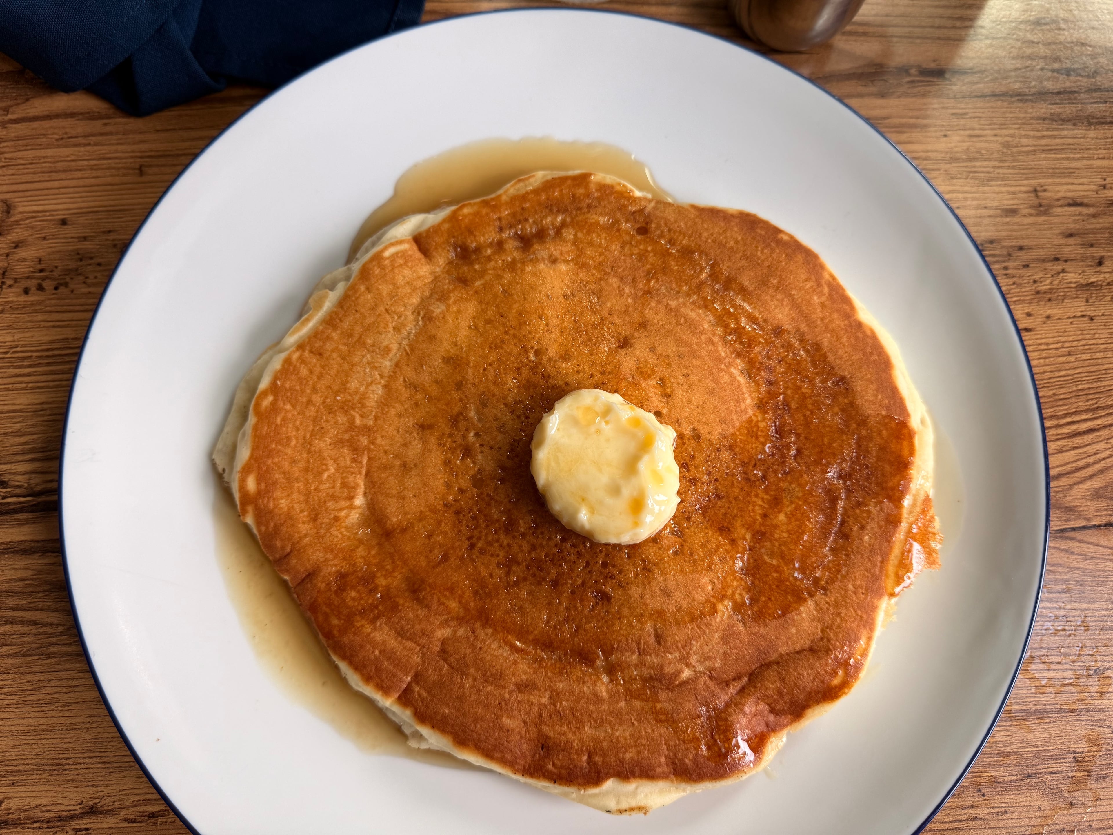 A pancake with butter at Buttermilk Kitchen. (Justin Brown for the AJC)